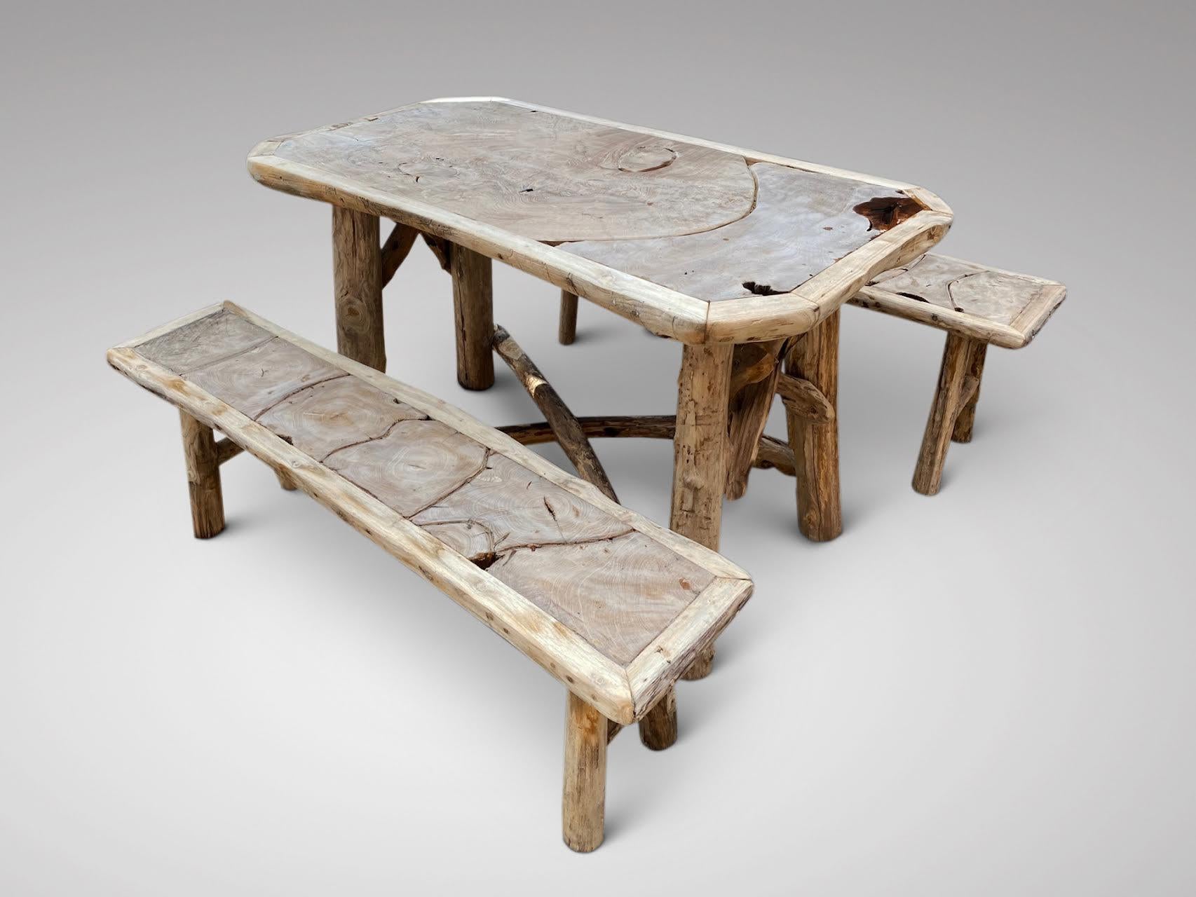 A quirky 20th century unusual rustic garden furniture set made from driftwood and olive wood. The set comprises of a table and two matching benches. The table top with solid olive wood top and driftwood to the edges and base. The benches have olive