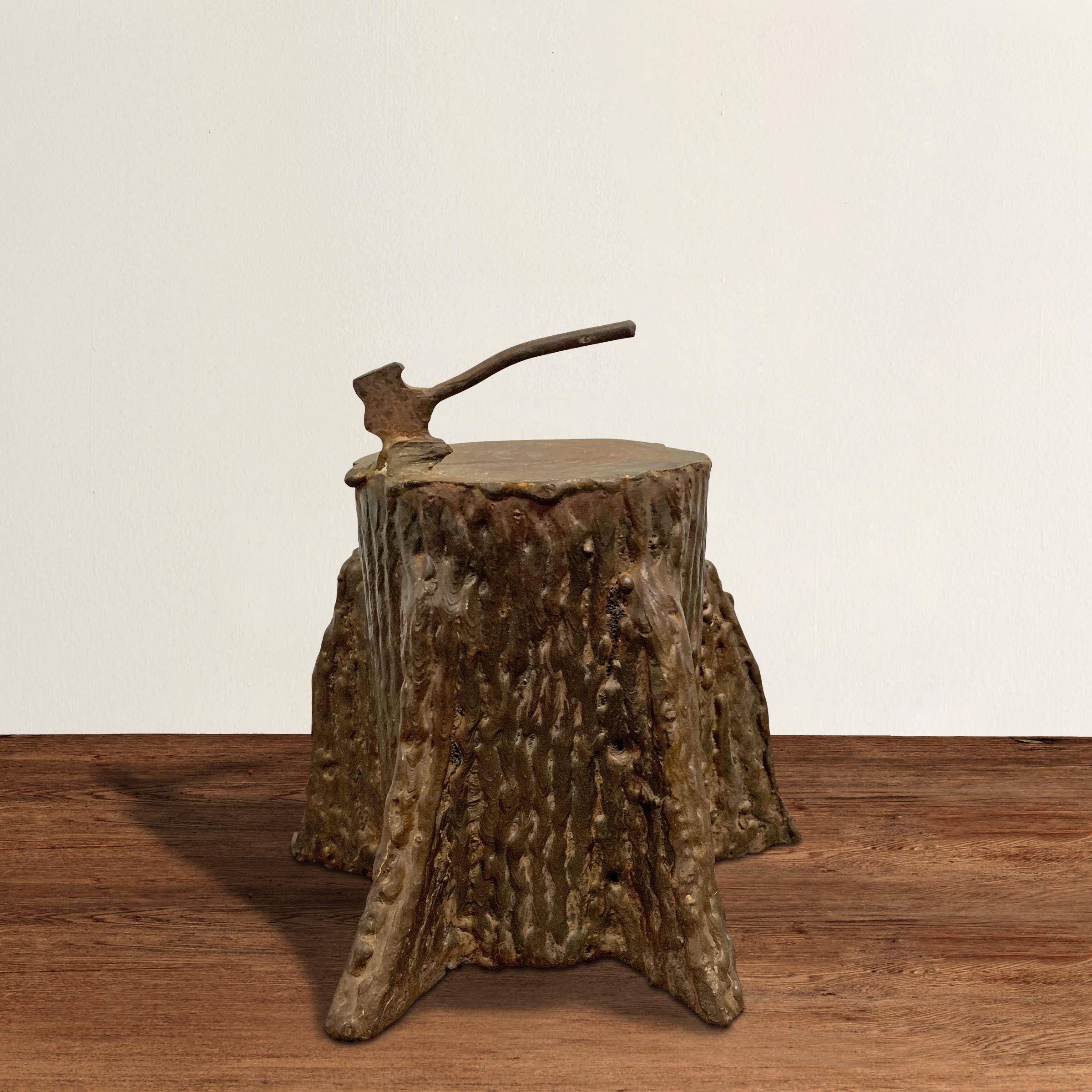 A quirky mid-20th century American Folk Art iron tree stump with attach wrought iron ax, and applied roots with a wonderful applied bark texture. Rings can be seen on the top of the stump. We don't know what this was intended to be used for, but we