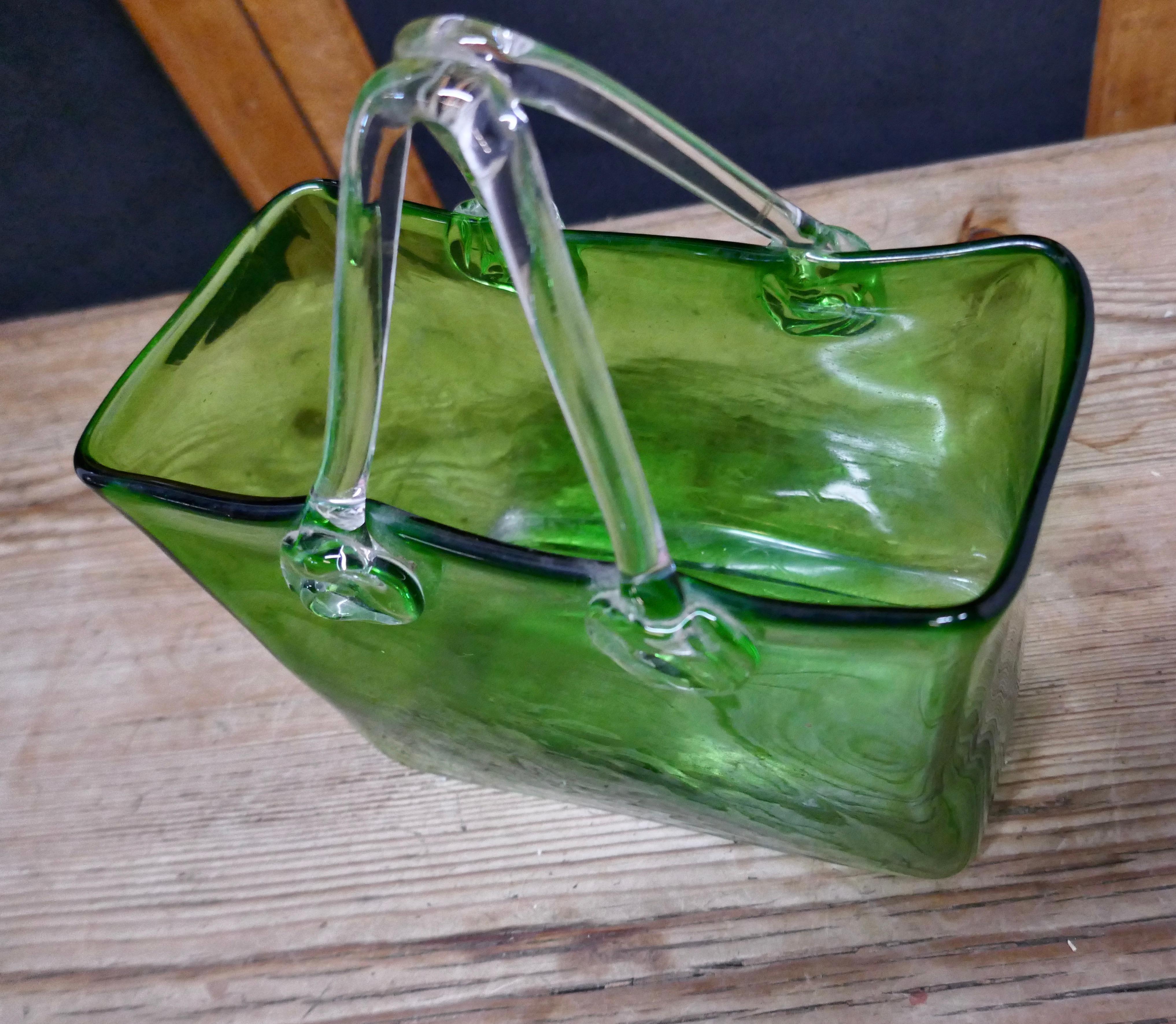 Quirky Art Deco hand blown green glass handbag vase.

A great bit of fun, this little hand bag, handmade in green glass with clear handles, originally a vase but with a modern twist and the addition of some fairy lights can be changed into a very