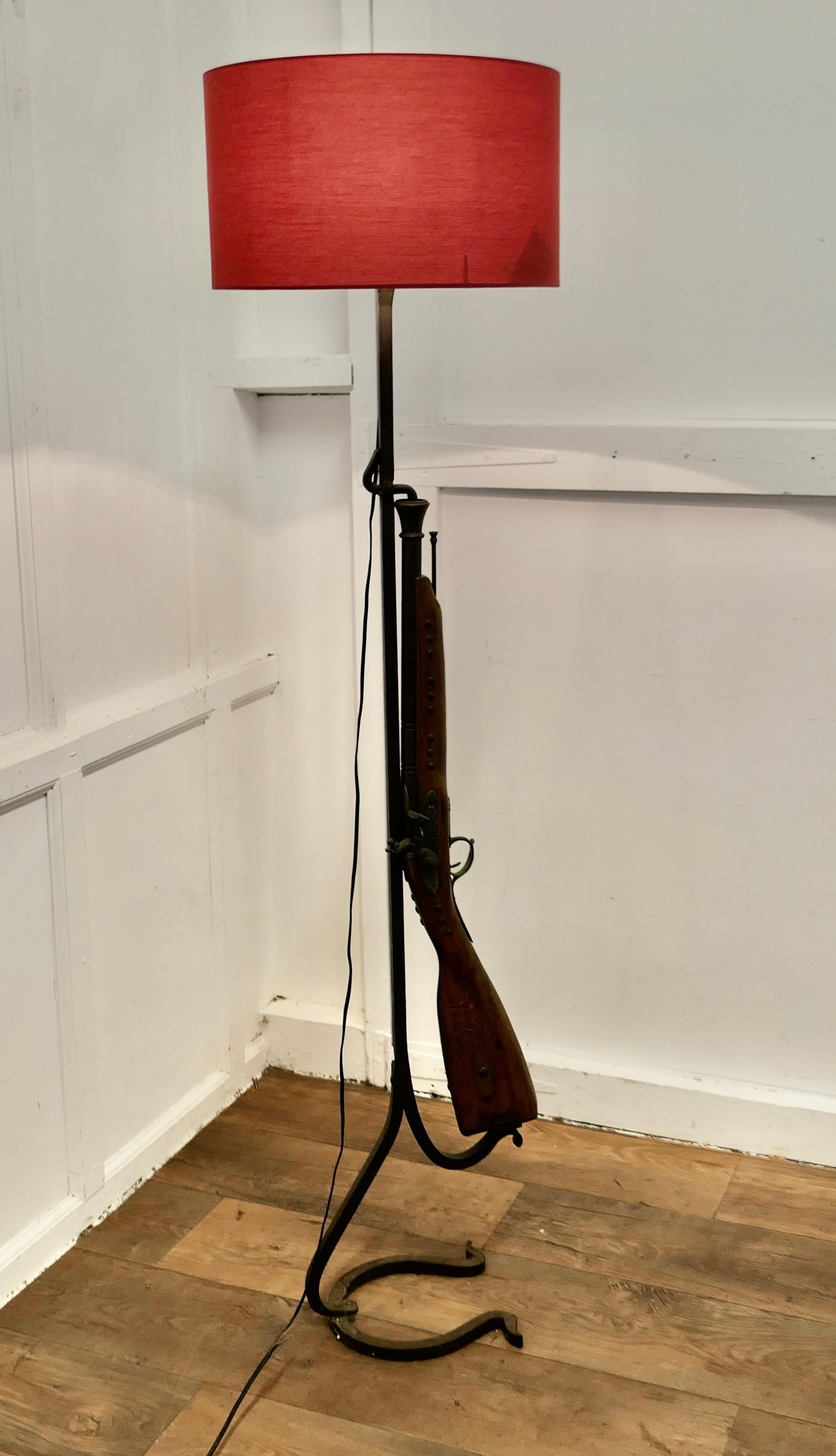 Quirky Hunting & Shooting Floor Lamp

A great piece made by a blacksmith on a wrought iron stand, it has a Horseshoe shaped base and the upright has a realistic looking imitation Flint Lock Rifle complete with ram rod, needless to say this is not a