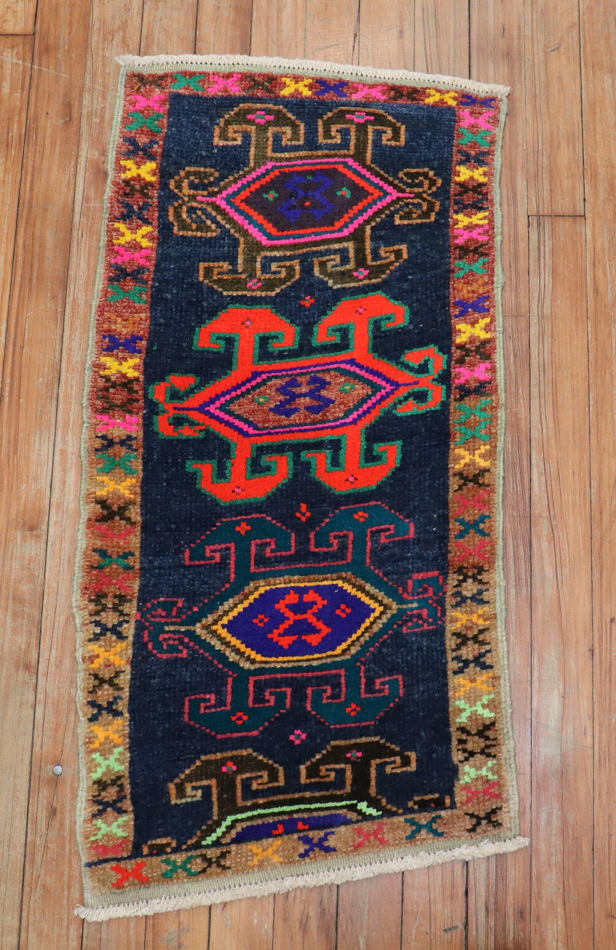 Quirky vintage Turkish Anatolian rug featuring vibrant colors on a charcoal field

Measures: 1'4' x 2'9