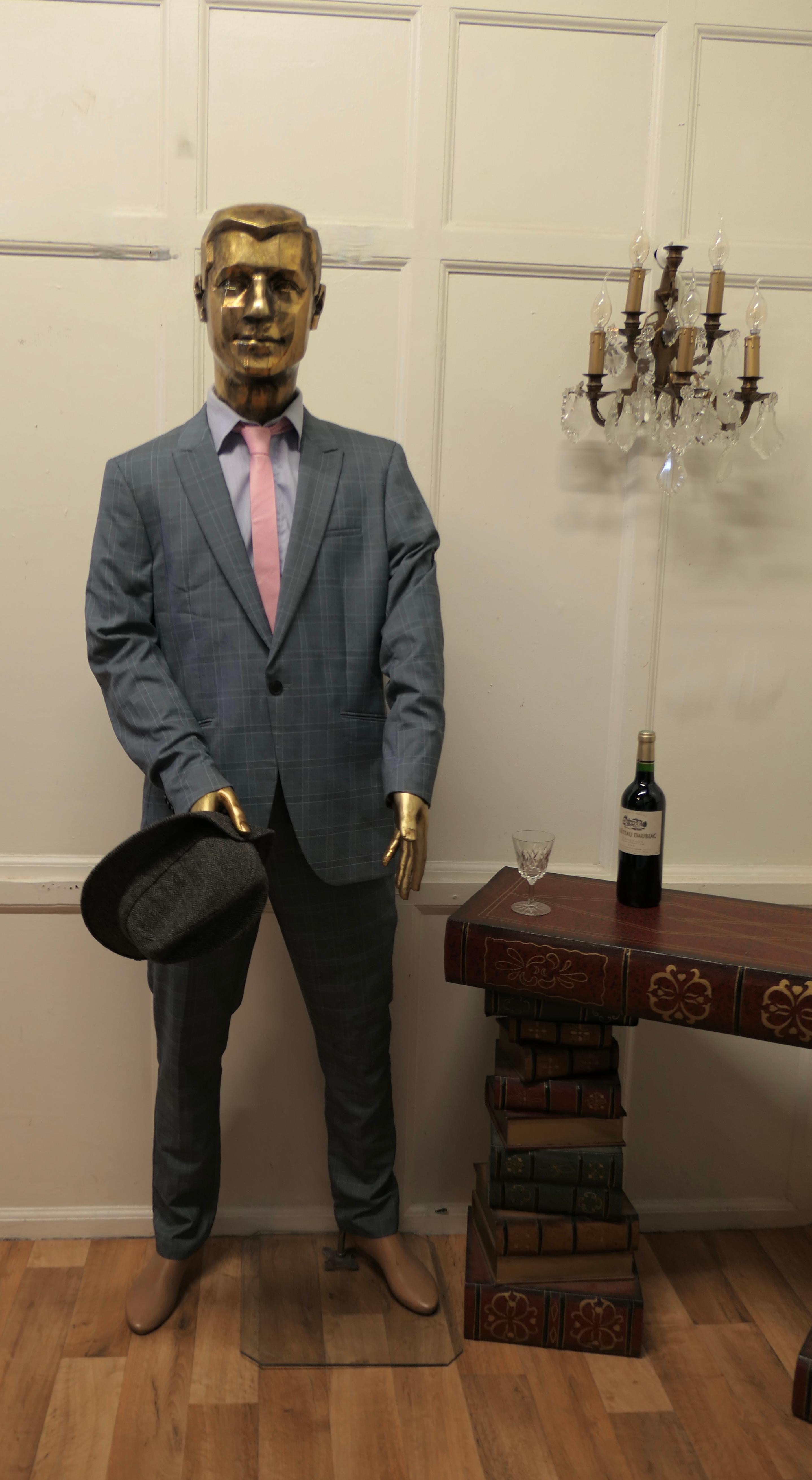 Quirky offbeat vintage male shop mannequin

A Striking Vintage Mannequin with a Gold Head and Hands, he is made in fibreglass with articulated wooden arms
This is a superb quality piece, he is set on a Plate Glass stand he has a large opening in