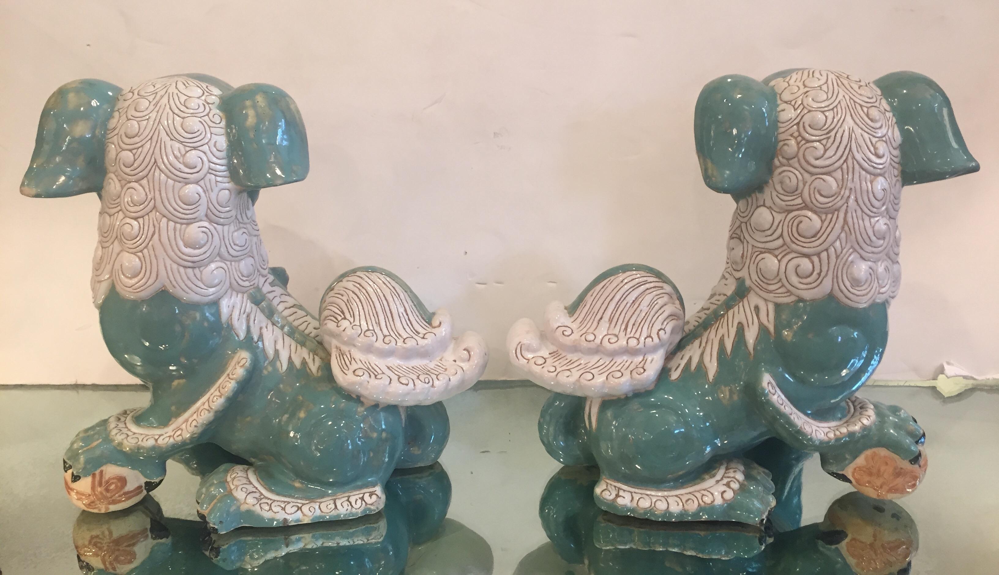 A stylish and large pair of Chinese ceramic foo dogs with wings in a lovely color palette of soft turquoise and cream.
