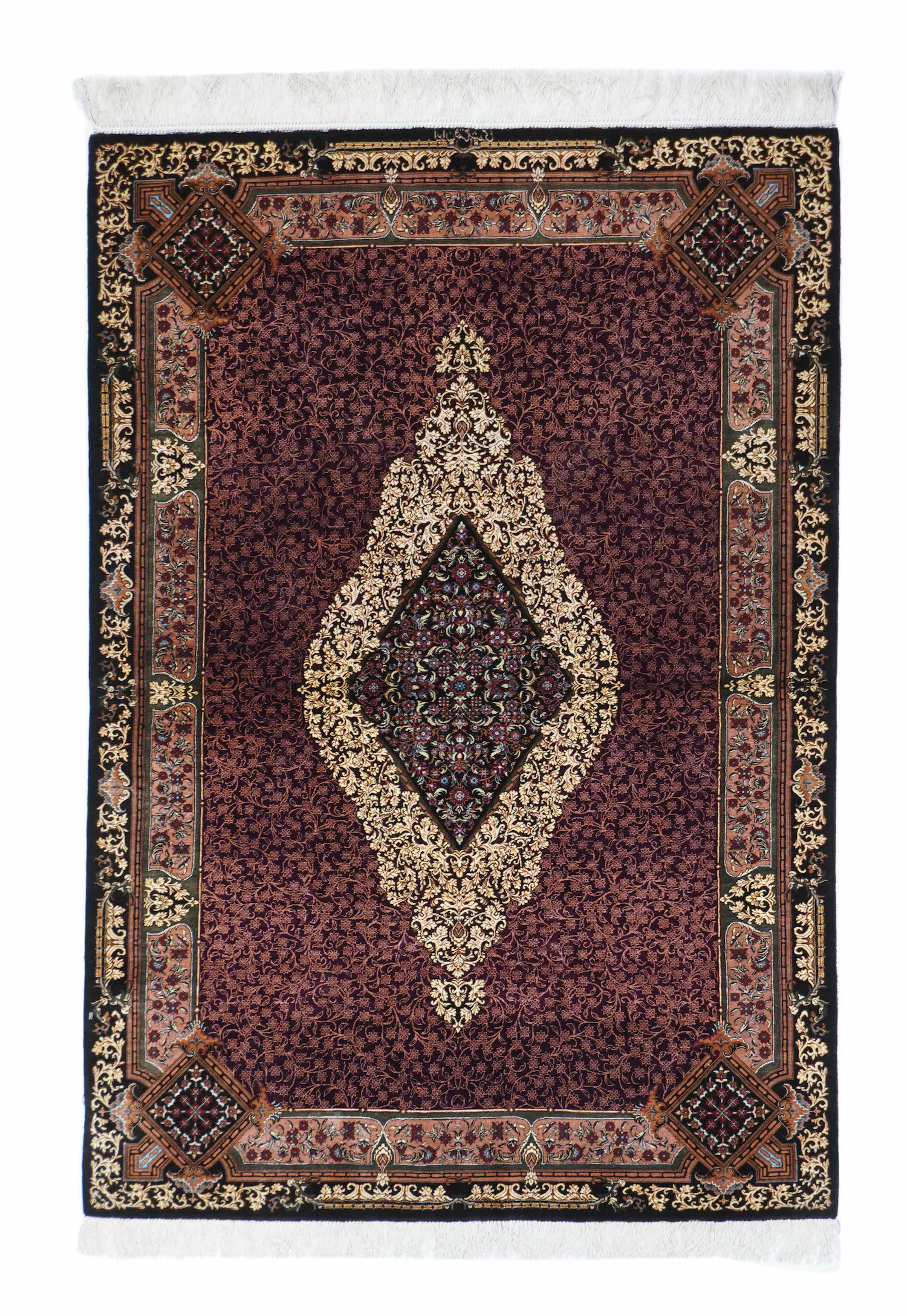 This extremely finely woven, densely detailed modern central Persian silk pile scatter shows a particularly dense design of leaves, blossoms and stems on a midnight ground with a central off white tall narrow medallion and a Navy conforming