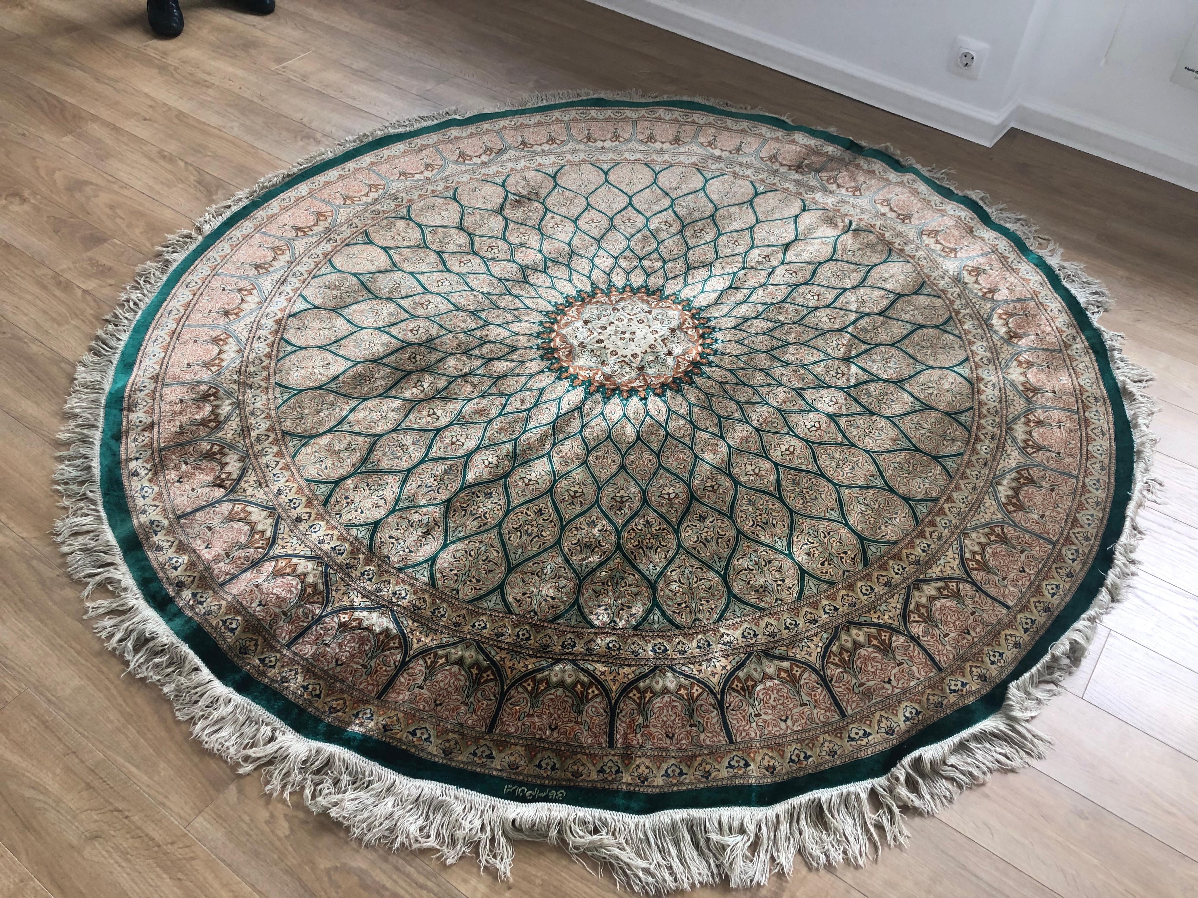 Very beautiful signed vintage Persian Qum Kazemi silk rug with floral decoration in green and red colors in very good condition. Made of 1100000 knots per sq. m.