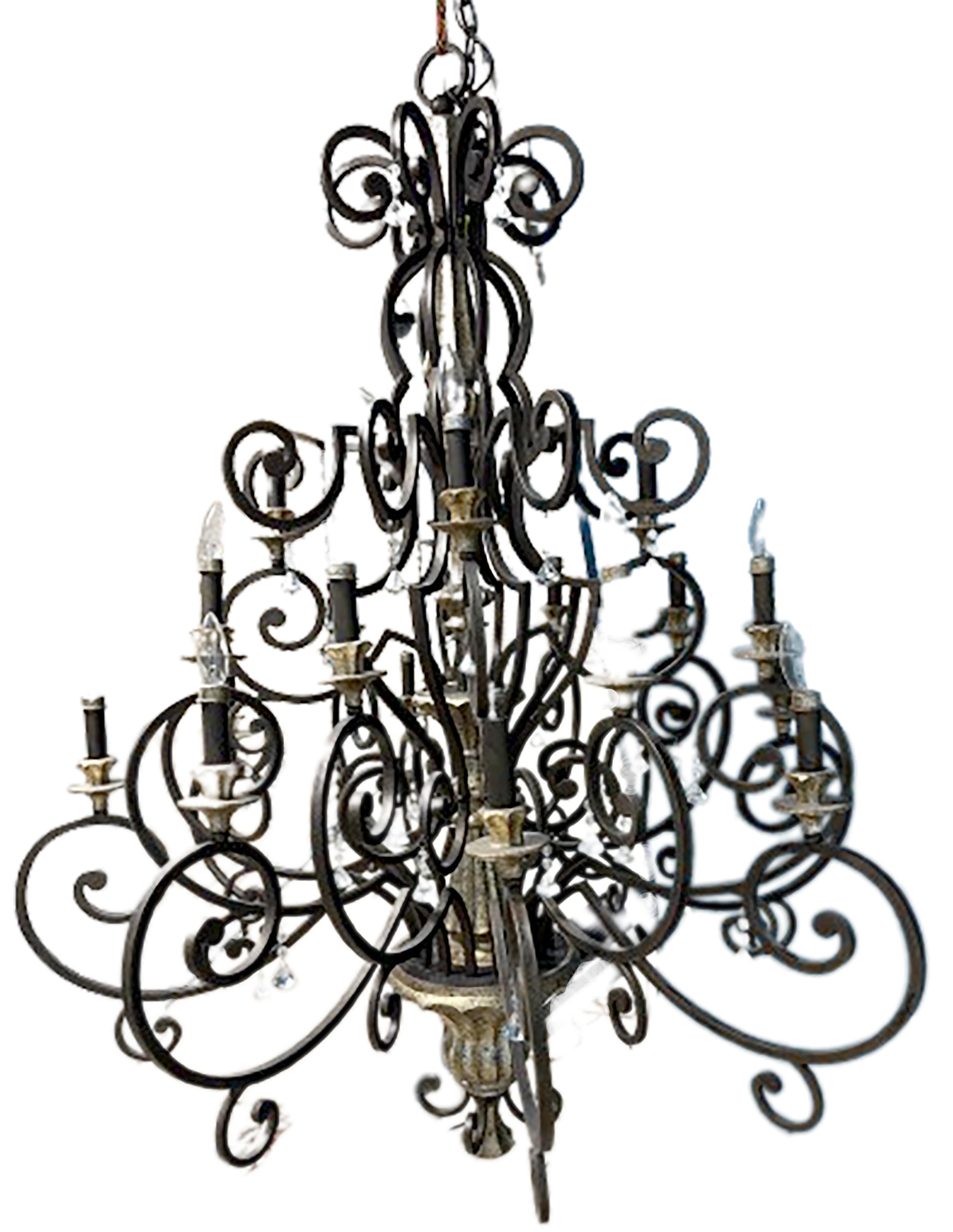 A handsome Quoizel Marquette 3-Tier Chandelier handmade chandelier. Made in a unique Heirloom finish that combines bronze and silver accents. Iron with French curve shapes rounding out the body of the piece. Contains a multitude of Hand cut crystal