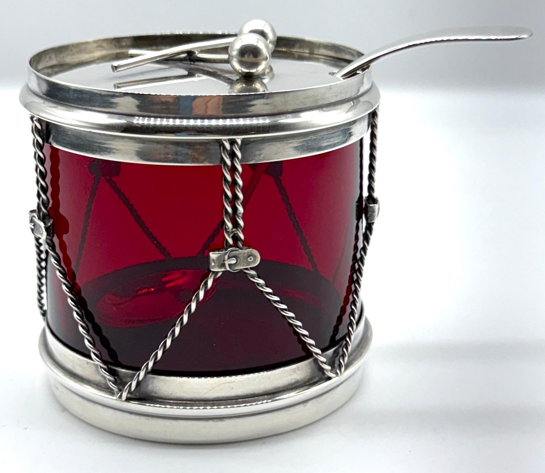 R. Blackinton & Co. Sterling & Red Glass Drum Condiment Jar & Serving Spoon, USA, Circa 1950s

This whimsical vintage sterling silver and red glass drum-shaped condiment jar, crafted by R. Blackinton & Co. in the 1950s, is a delightful novelty piece