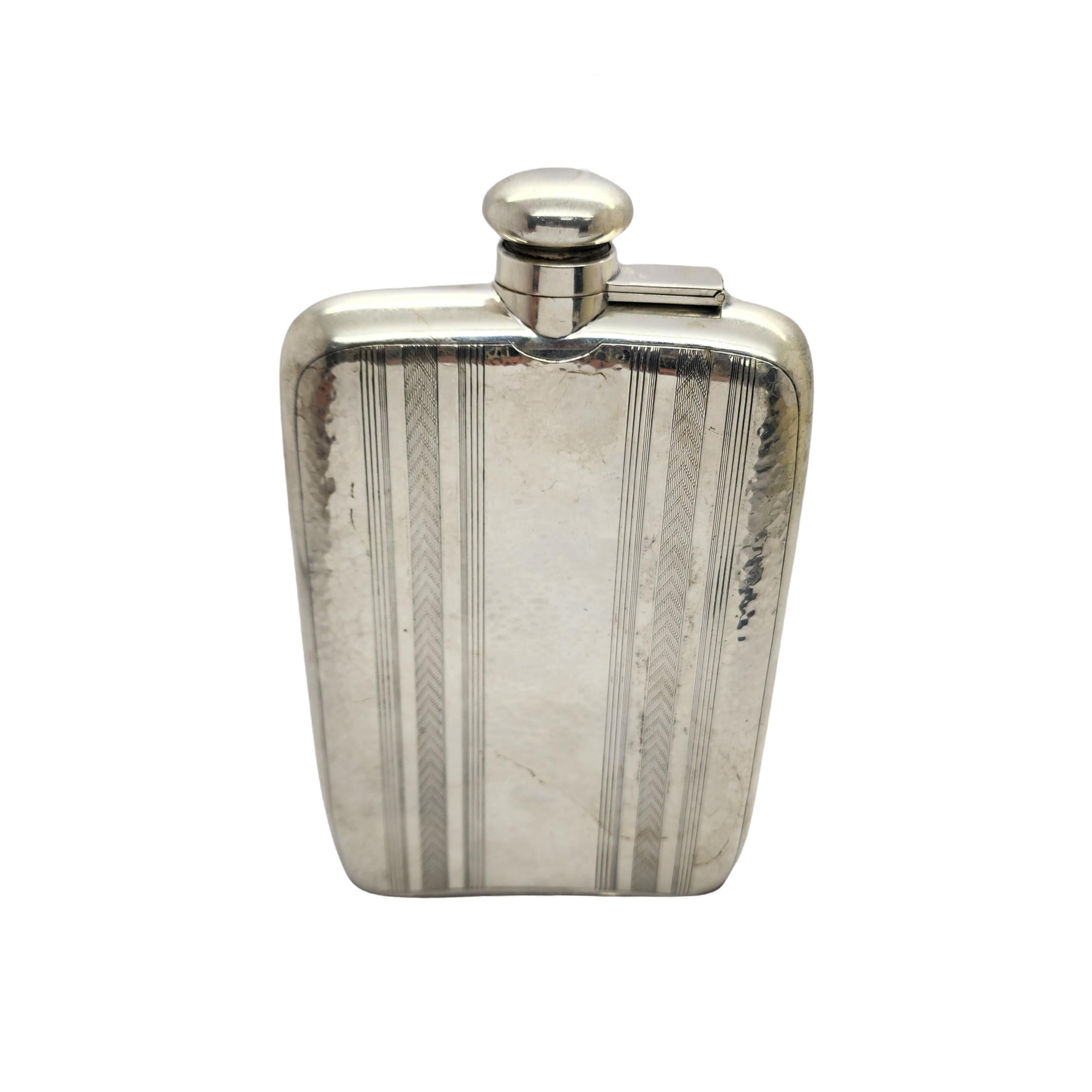 Sterling silver hip flask by R. Blackinton & Co with monogram.

Monogram appears to be BRS

Beautiful curved hip flask featuring a hammered finish with striped and V design stripes, and a screw top with original inner cork. Hold 3/4 pint.

Measures
