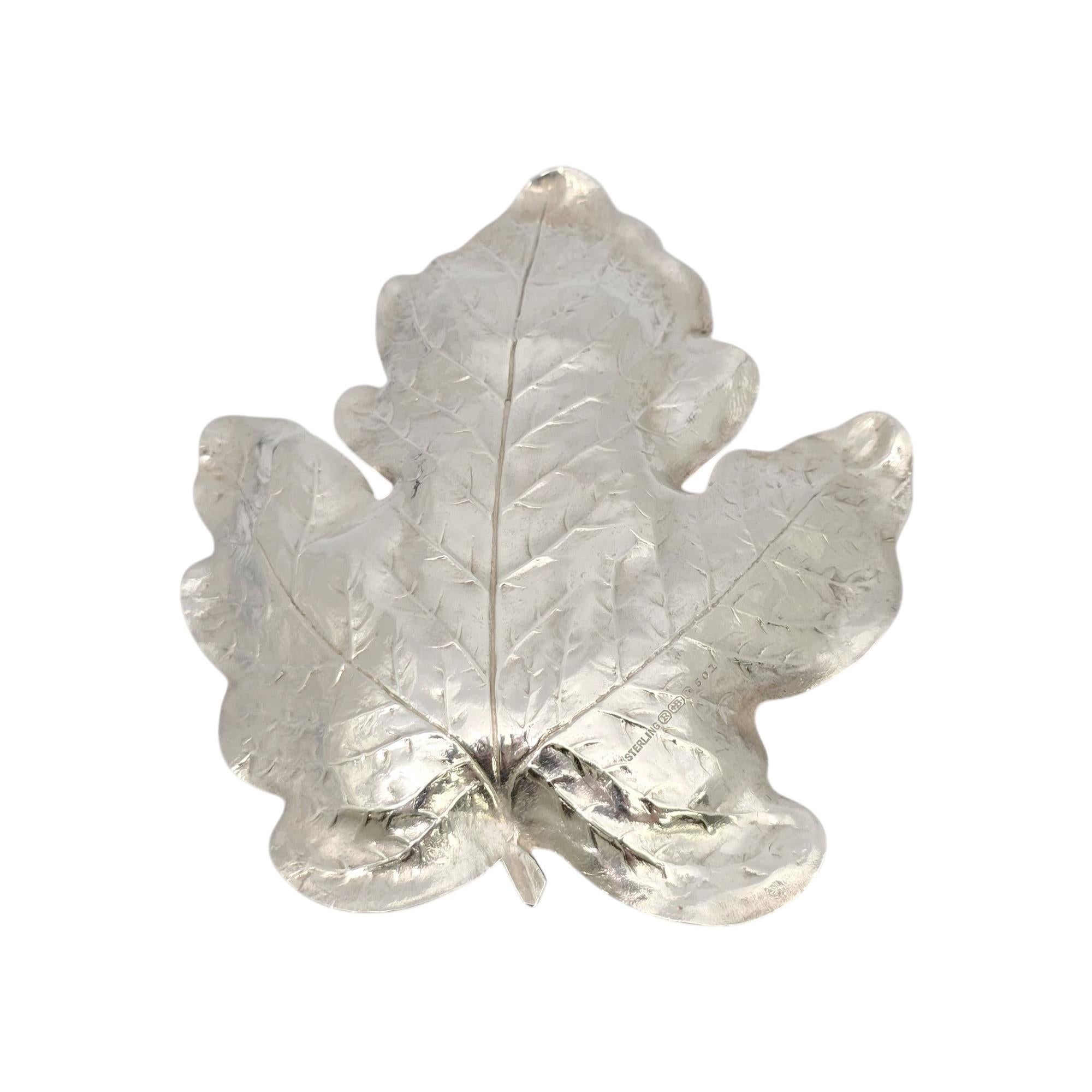 Sterling silver Oak Leaf dish by R Blackinton and Co, pattern #501.

This beautiful dish is crafted in sterling silver and features an ornate and detailed design of an oak leaf.

Measures approx 4 7/8 x 4