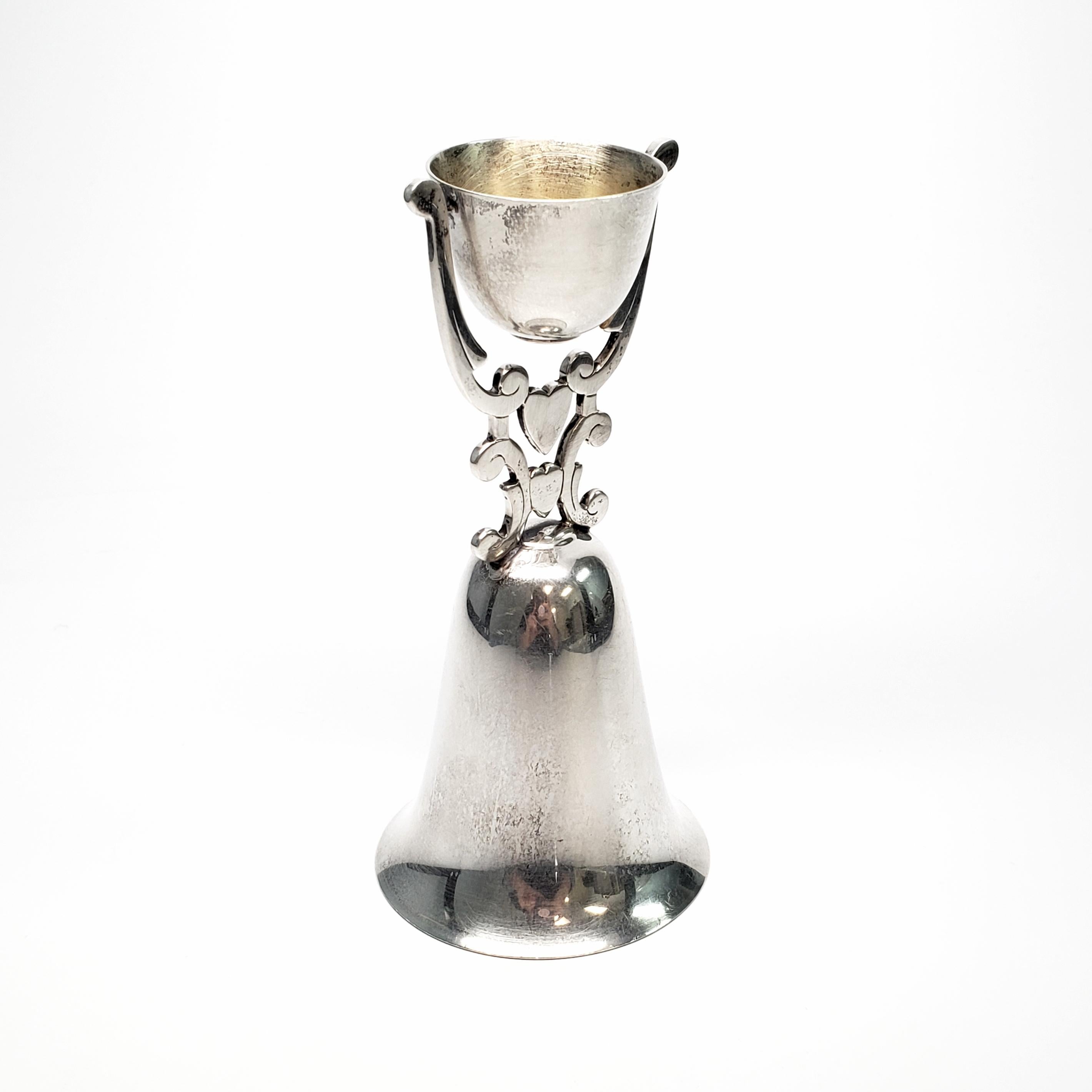 Vintage R. Blackinton sterling silver wedding cup.

Lovely swiveling cup with 2 hearts and scroll design. Both bride and groom can drink out of it simultaneously, based on the story of the Nuerenburg Bridal Cup of 15th Century Germany.

Measures