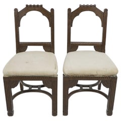 R Boyd. in the style of Dr C Dresser. A pair of oak side chairs