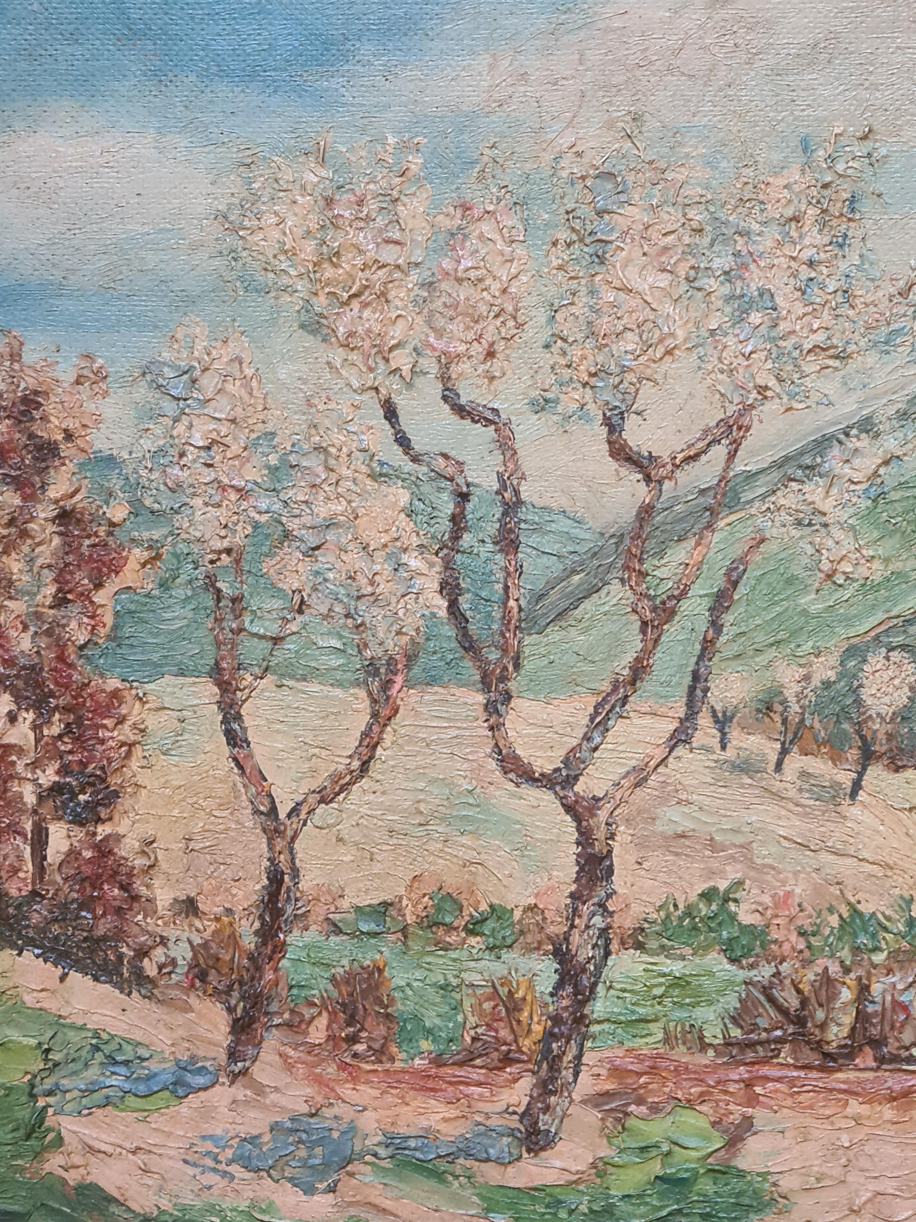 French Impressionist landscape of the almond trees in blossom at St Etienne Les Orgues in the South of France. The painting is located and dated front right and signed, dated and located two times to the backboard. Presented in patinated wood