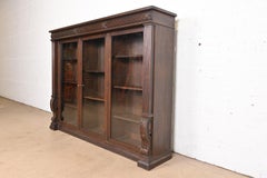 R. J. Horner Style American Empire Carved Oak Glass Front Triple Bookcase