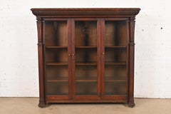 R. J. Horner Style American Empire Carved Oak Glass Front Triple Bookcase