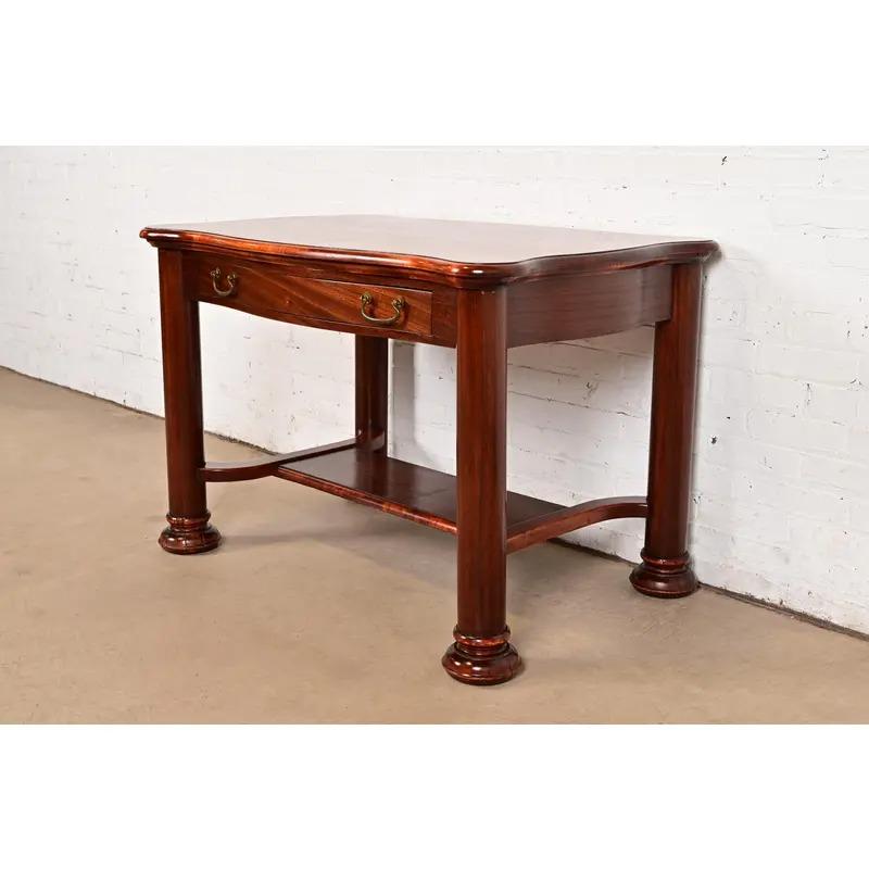 A gorgeous antique American Empire writing desk or library table

In the manner of R.J. Horner & Co.

USA, Circa 1890s

Carved mahogany, with original brass hardware.

Measures: 42