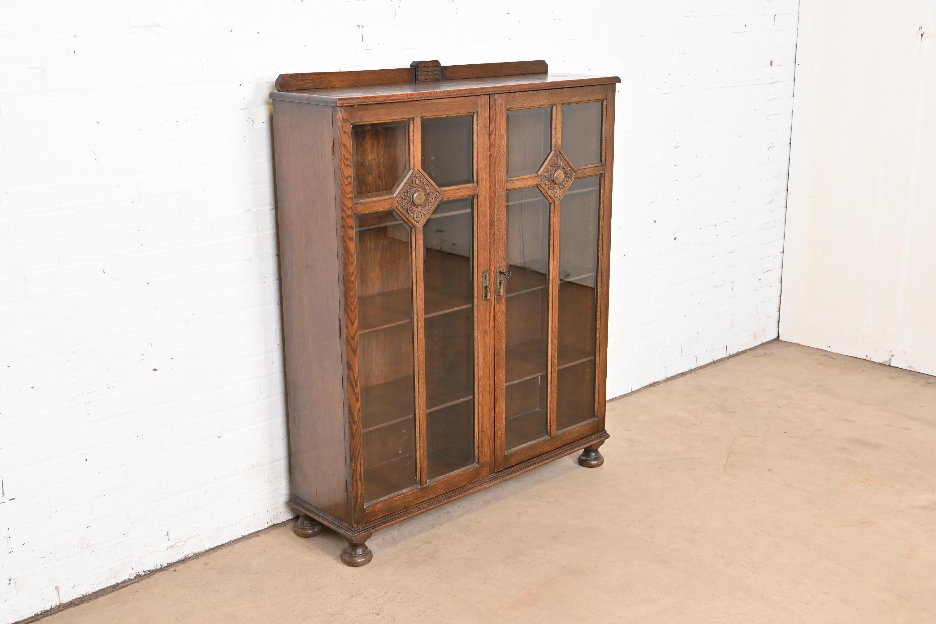 R. J. Horner Style Antique English Tudor Carved Oak Glass Front Double Bookcase In Good Condition In South Bend, IN