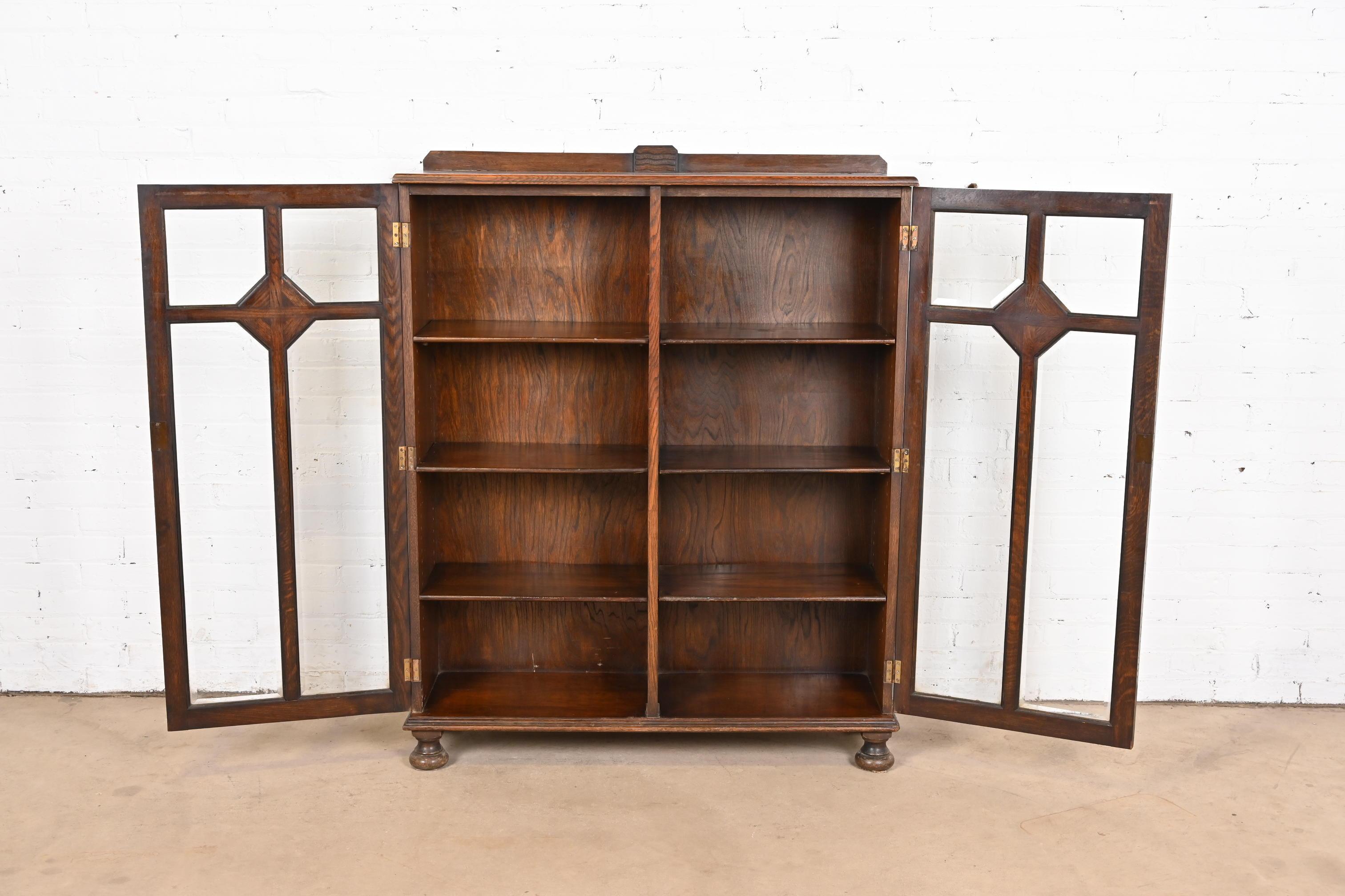 20th Century R. J. Horner Style Antique English Tudor Carved Oak Glass Front Double Bookcase
