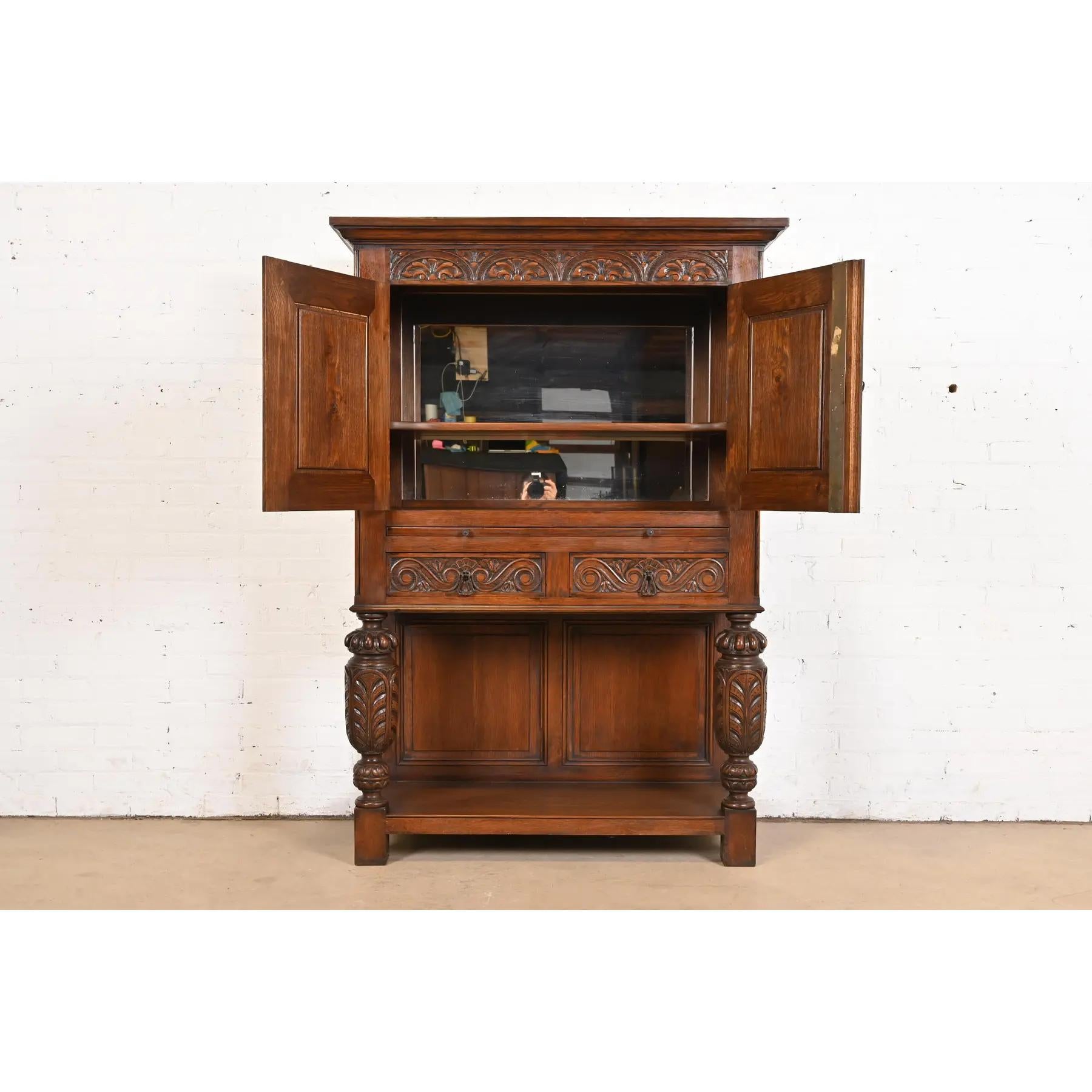 Early 20th Century R. J. Horner Style English Jacobean Carved Oak Bar Cabinet, Circa 1900 For Sale