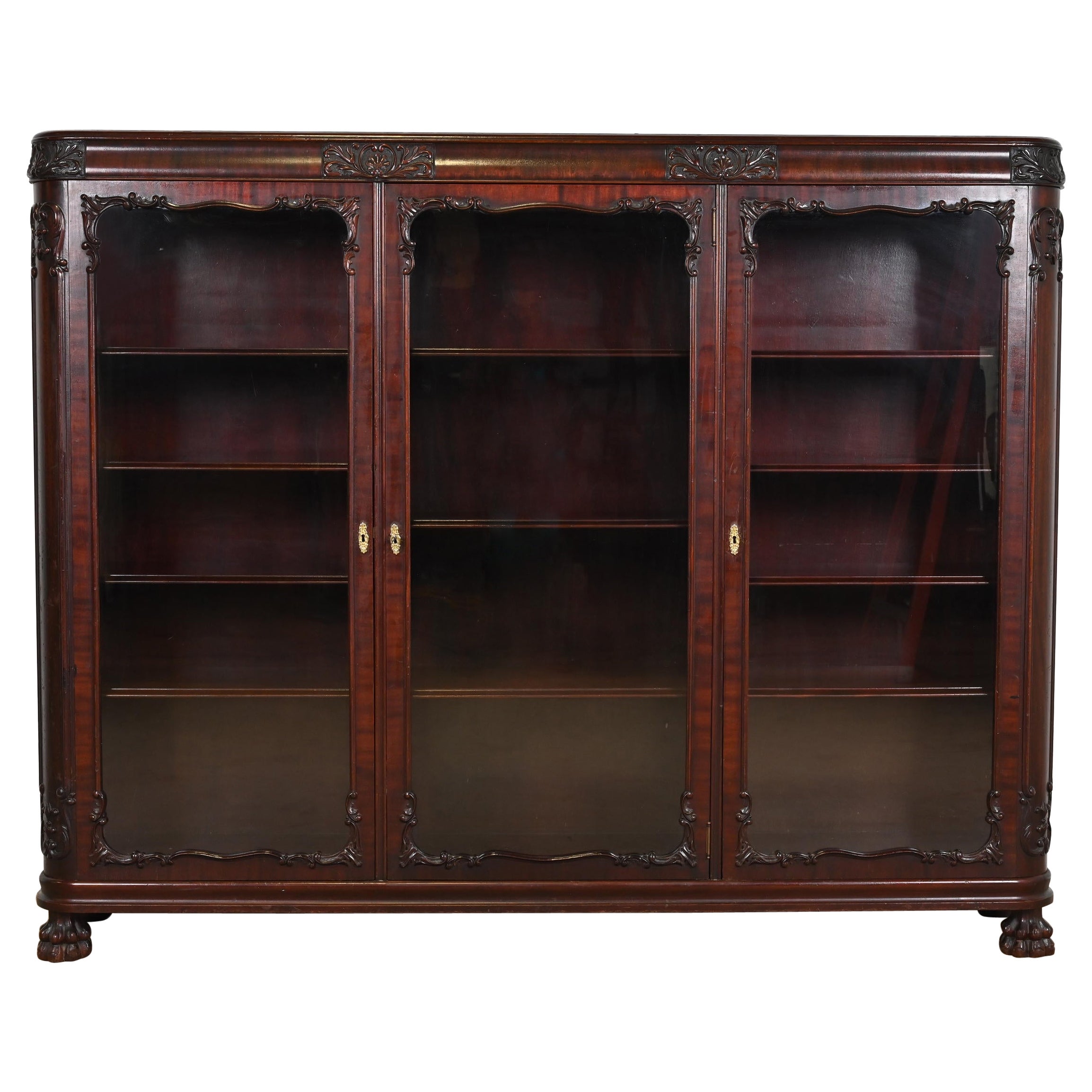 R. J. Horner Style Victorian Carved Mahogany Glass Front Triple Bookcase, 1890s