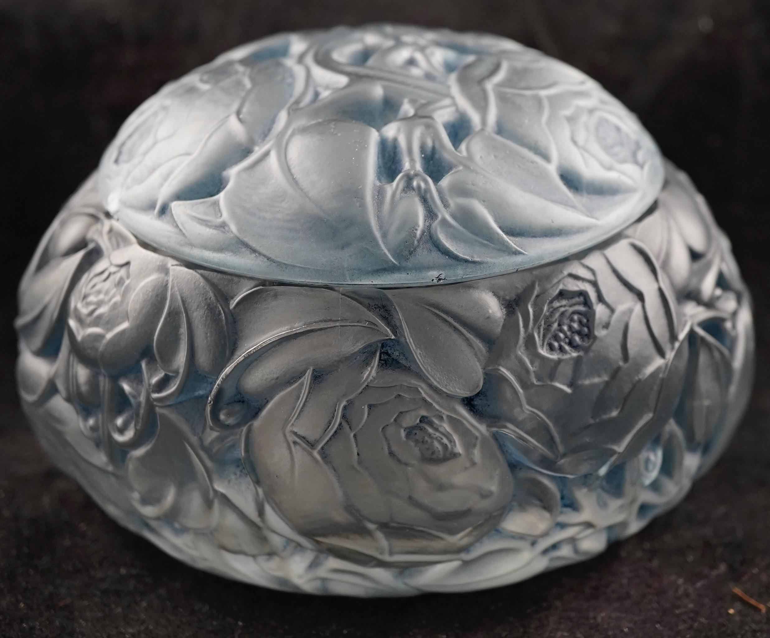 'Dinard' a Box and Cover, design 1927 frosted and polished glass, highlighted with blue staining 13cm long, moulded 'R.LALIQUE', and repeated engraved signature.