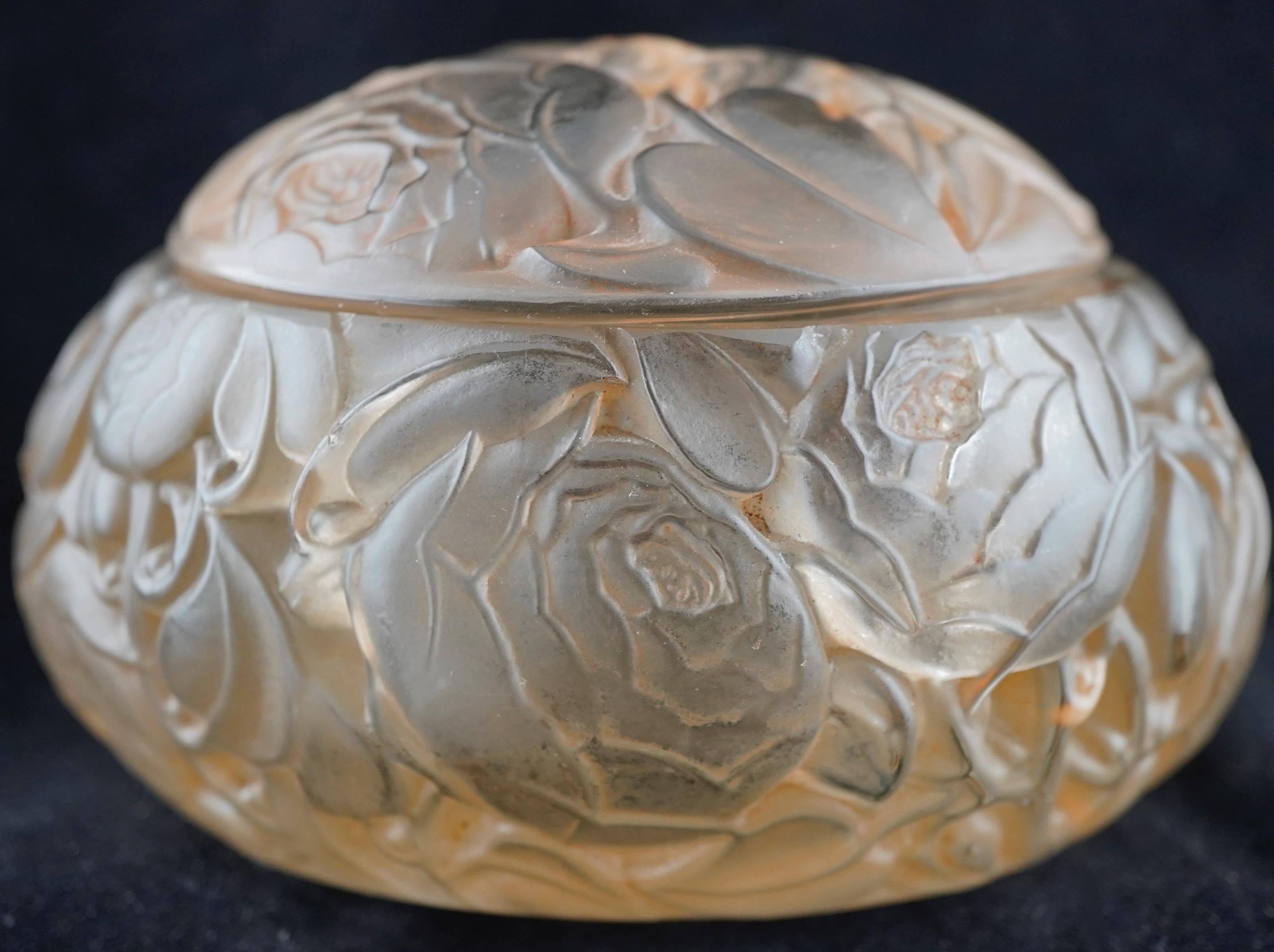 'Dinard' a Box and Cover, design 1927 frosted and polished glass, highlighted with blue staining 13cm long, moulded 'R.LALIQUE', and repeated engraved signature.