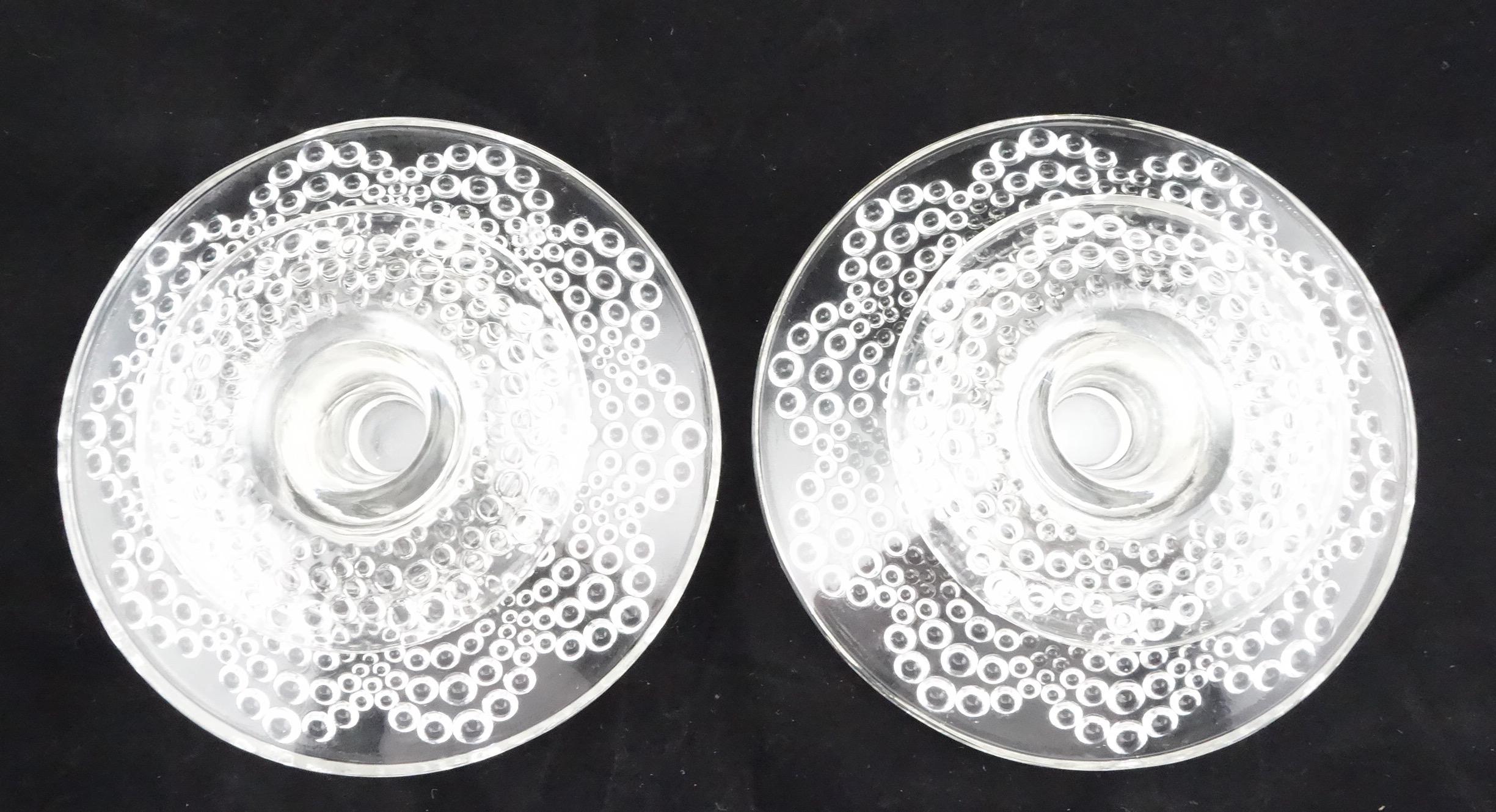 R Lalique pair of St. Gall candleholders, model from 1934. Each candleholder consists of a supporting dish with a candle dish on top. Each supporting dish marked with acid etched 