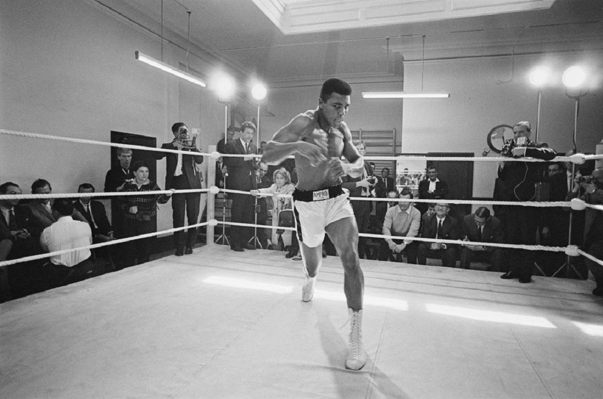 "Ali In Training" by R. McPhedran

American heavyweight boxer Muhammad Ali throws bare-handed punches in the ring while in training for his fight against Brian London, London, England, August 1966.

Unframed
Paper Size: 30" x 40'' (inches)
Printed
