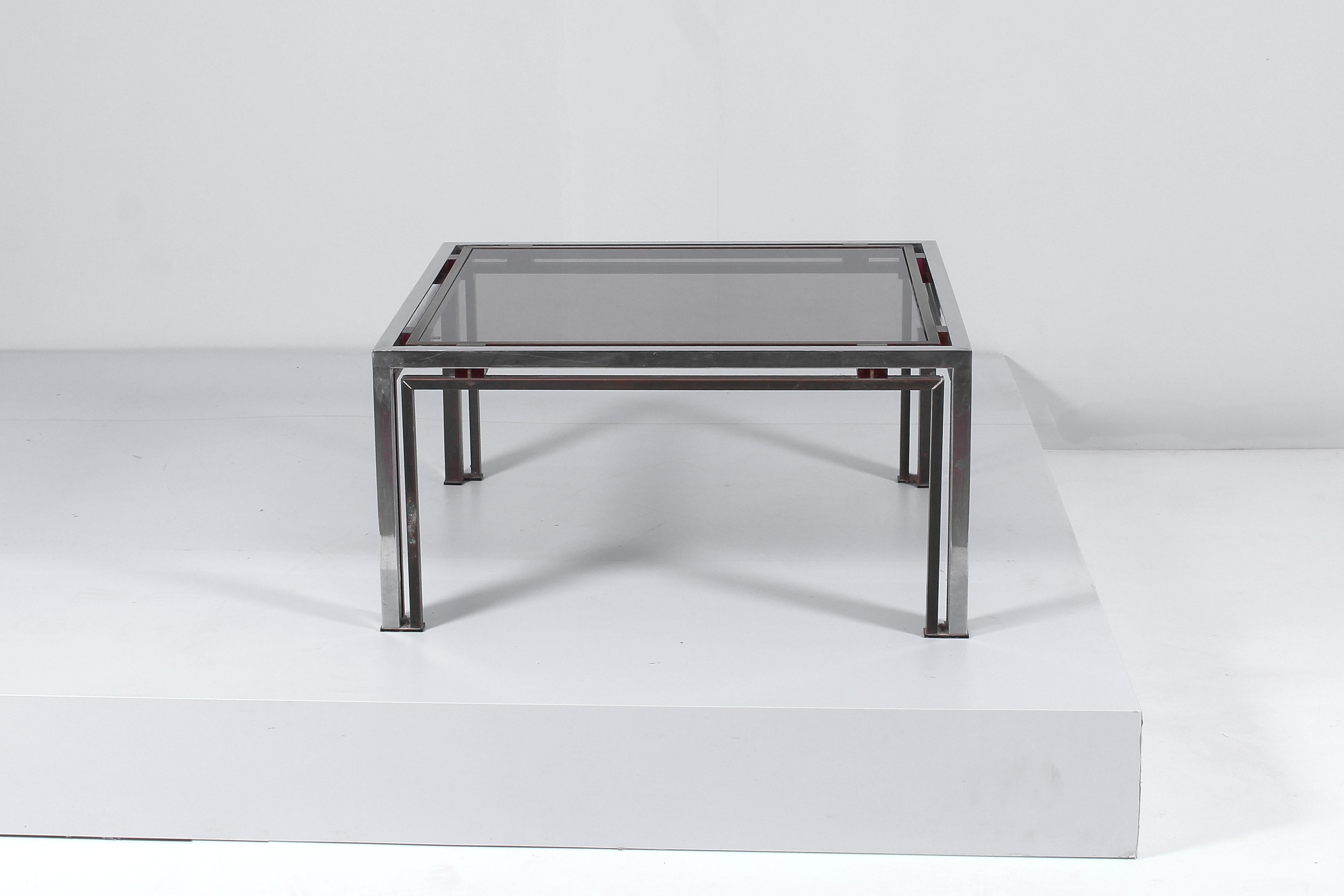 Coffee table in brass and chromed metal, Space Age genre, with geometric shapes with a square top in dark glass and support elements in red acrylic glass. By Romeo Rega for Nazareth, Italian production in the 70s.
Wear consistent with age and use.