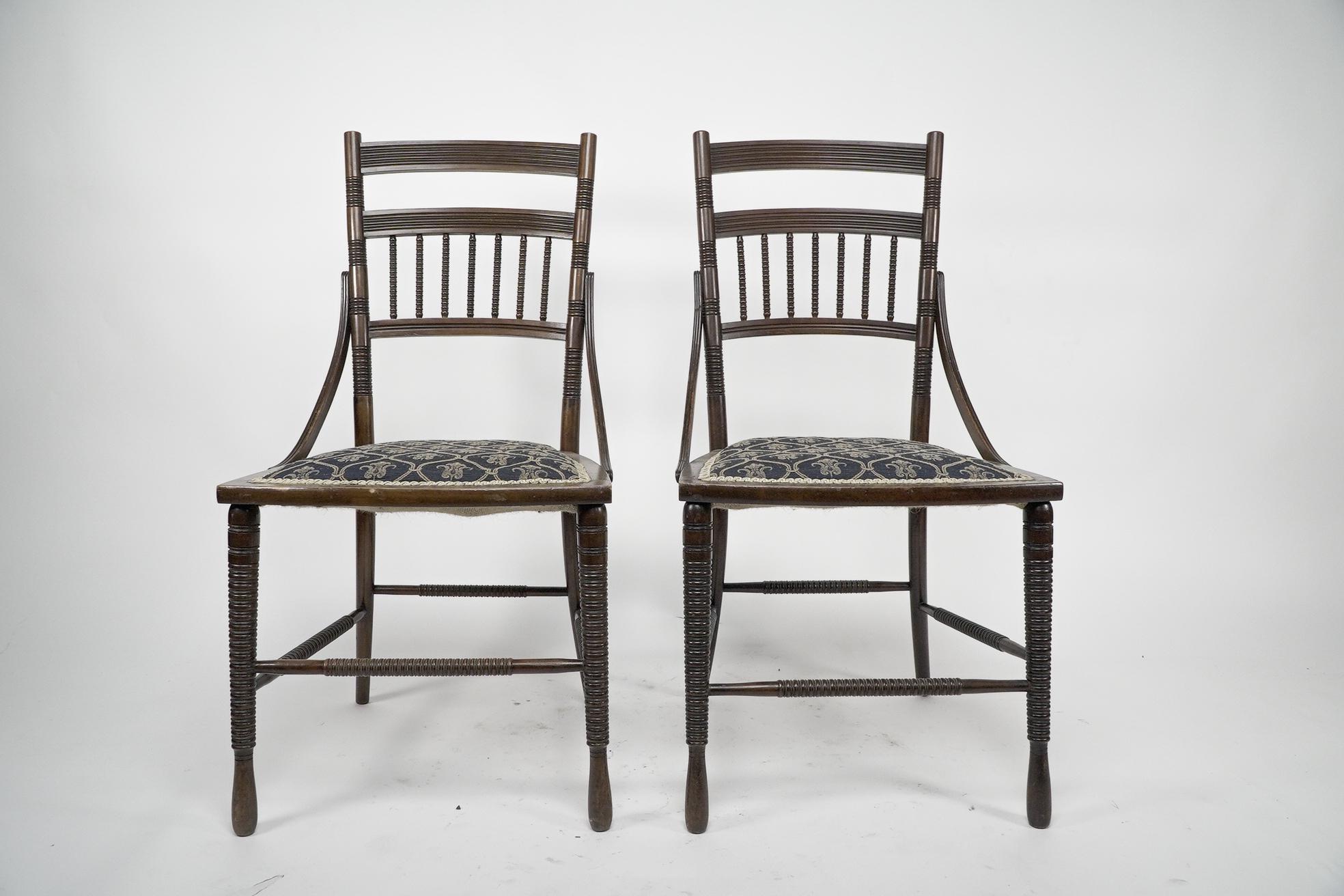 R. W. Edis, probably made by Jackson and Graham. A fine pair of Aesthetic Movement Walnut side chairs with fine ring turned and incised tramline details, and sweeping side supports. A chair of the same design was exhibited at The Health Exhibition