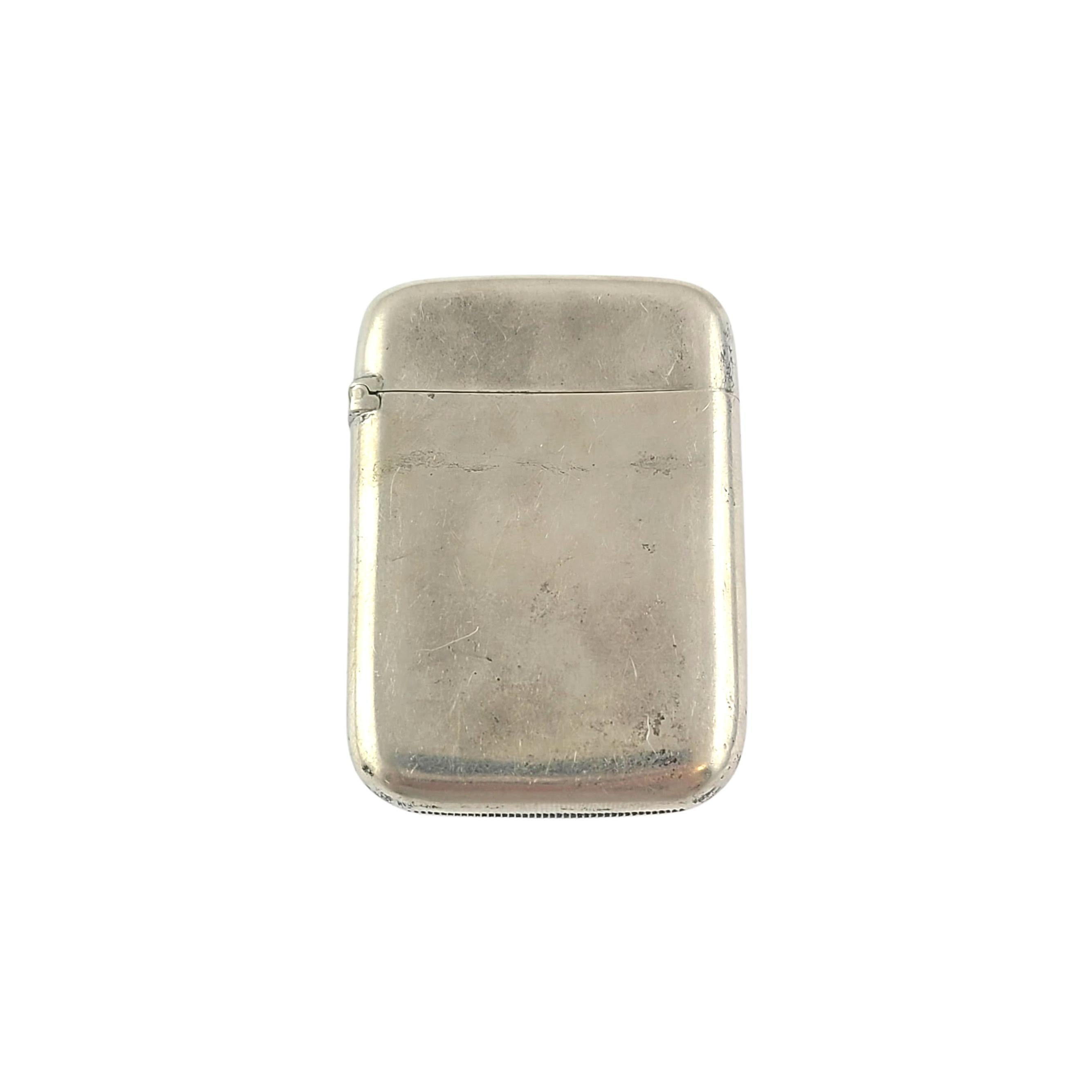 Sterling silver match safe/vesta case with monogram by R. Wallace & Sons Mfg Co.

This beautiful piece features a simple etched line design on one side, polished smooth on the other side. It has a well functioning hinge, and a striking surface on