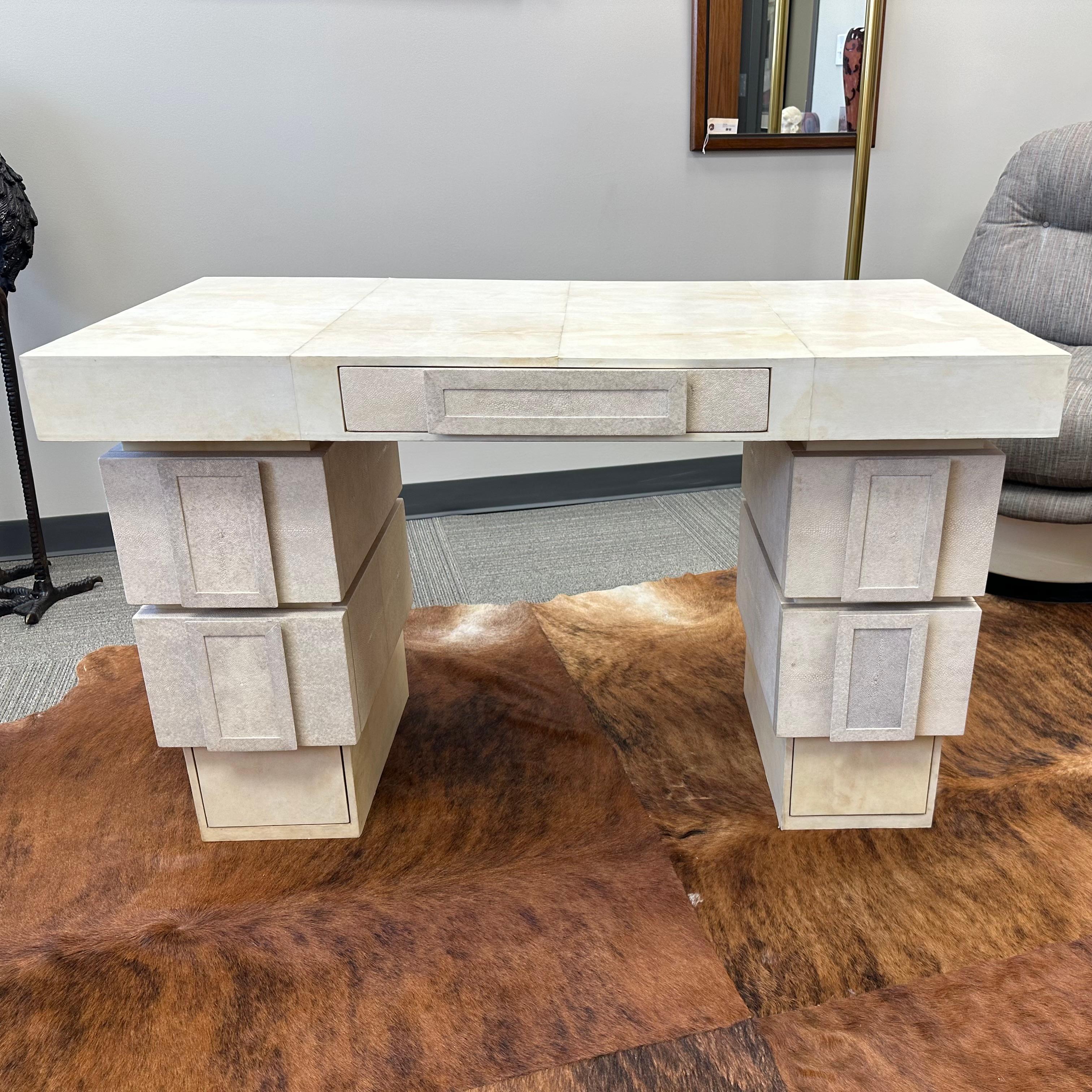 This exceptional desk was designed in the 1990s by husband-and-wife design team Ria and Yiouri Augousti of Paris, France. The surface and base of the desk is finished in parchment, while the rest of the piece is finished in shagreen. The desk is