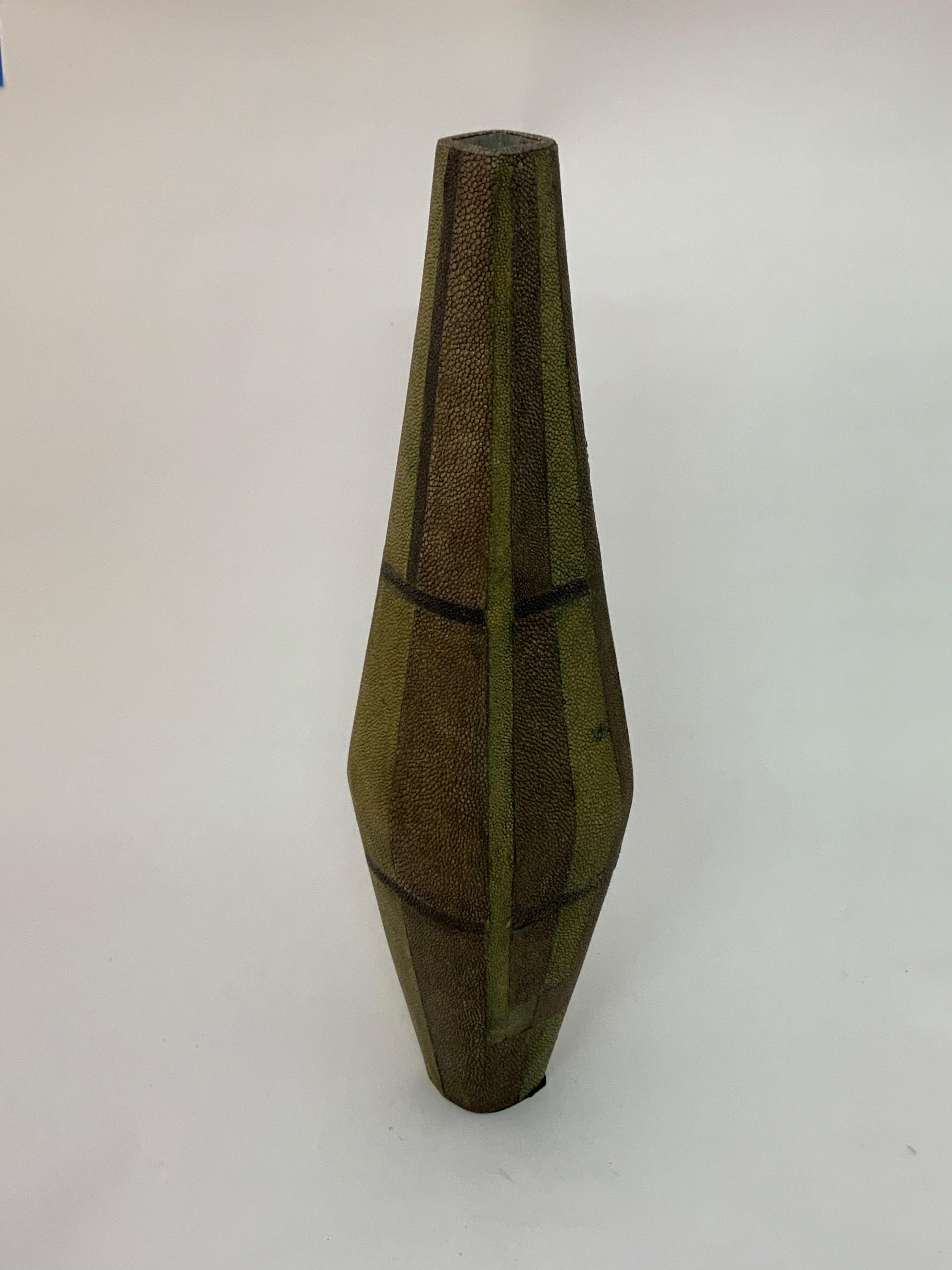 Tall and elegant shagreen clad vase by Ria and Yiouri Augousti. Fully signed on bottom. Geometric pattern of olive green, aubergine and light brown.

Measures: 16.25