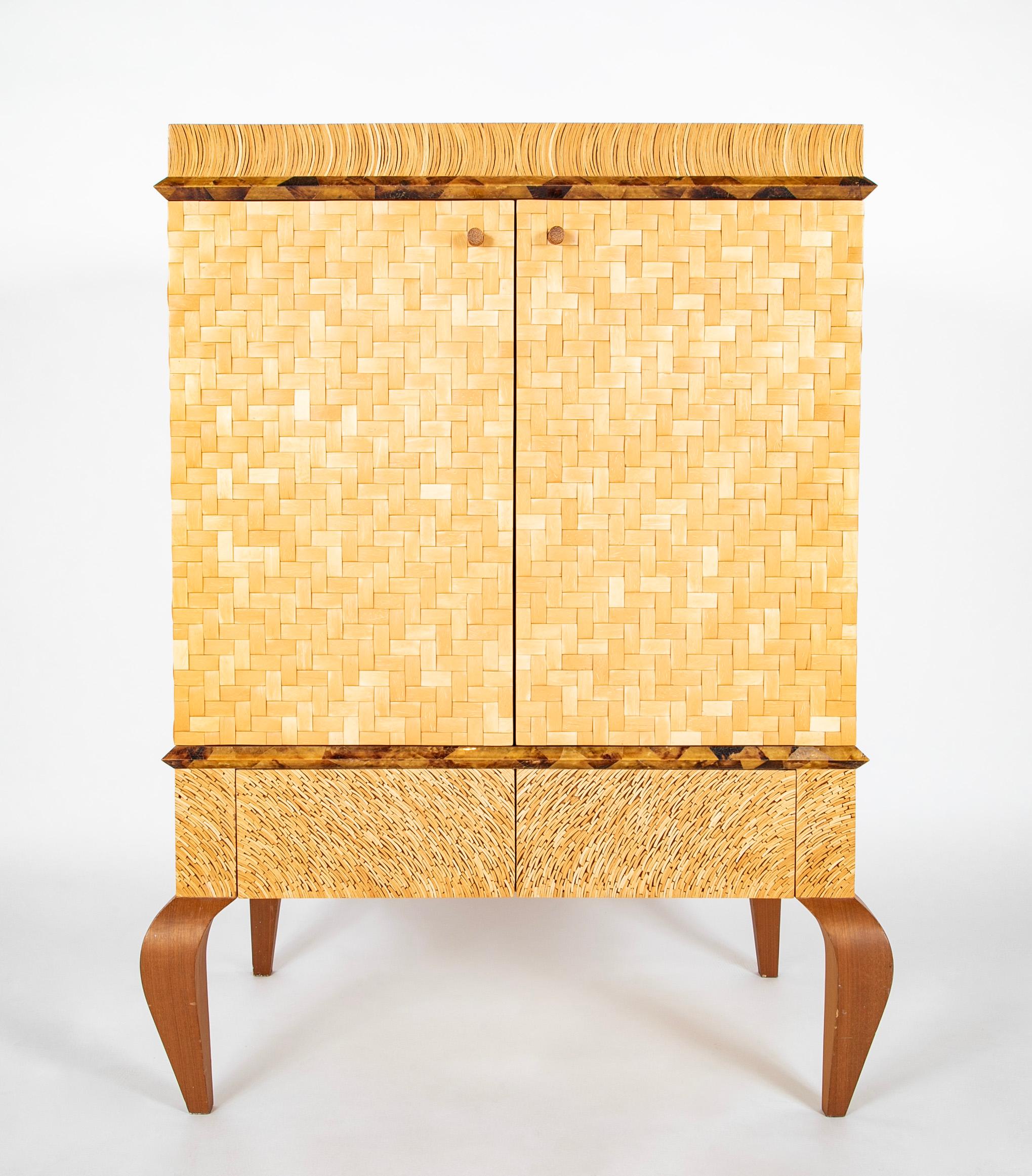 Absolutely stunning two door cabinet made with a array of natural materials, wove bamboo doors and sides, sliced lacquered bamboo top and drawers, with eggshell lacquer interior doors, pen shell trim. All supported on sculpted mahogany cabriole