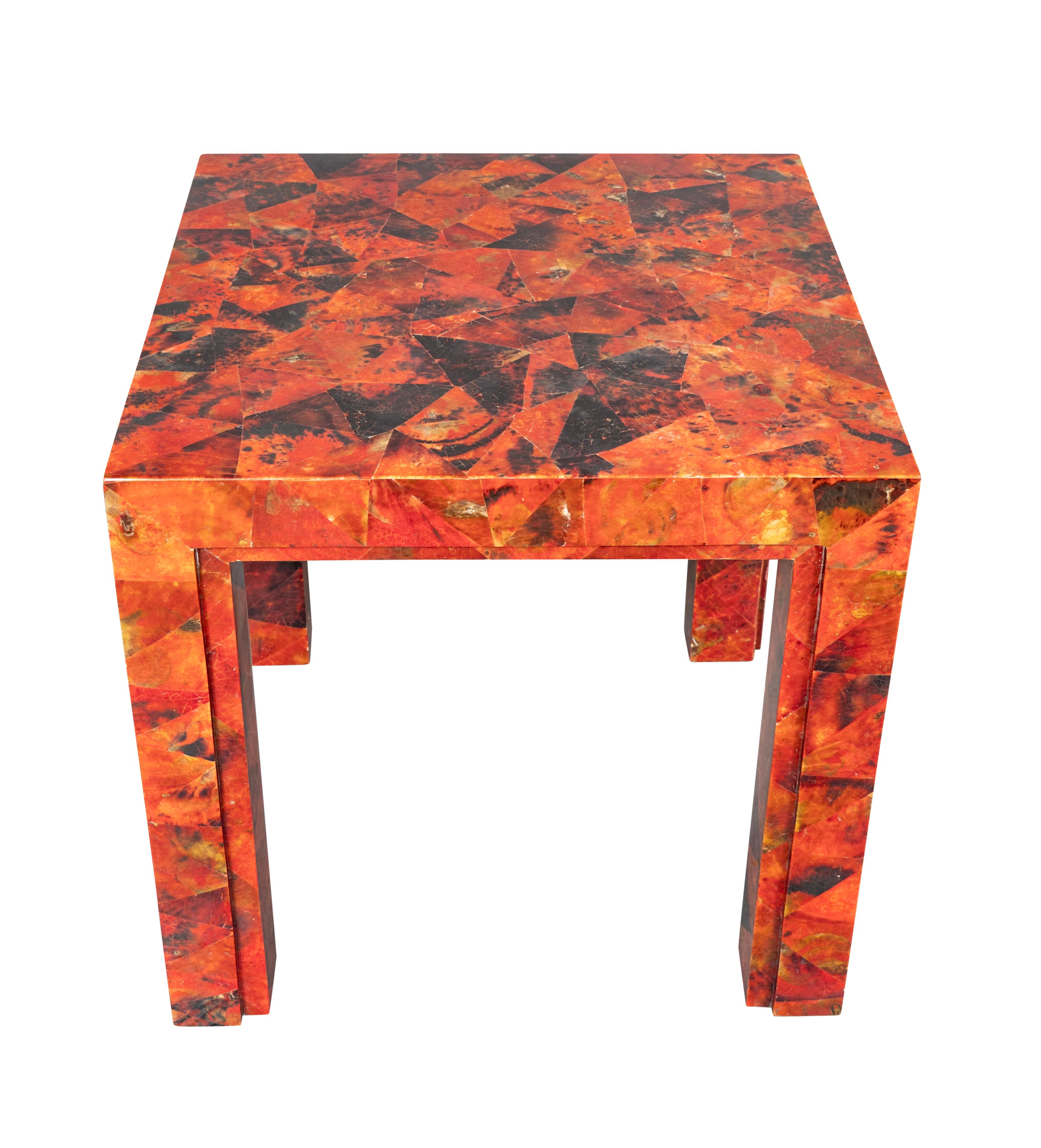 Modernist square low table in red tessellated horn. Square section legs. Signed under top.