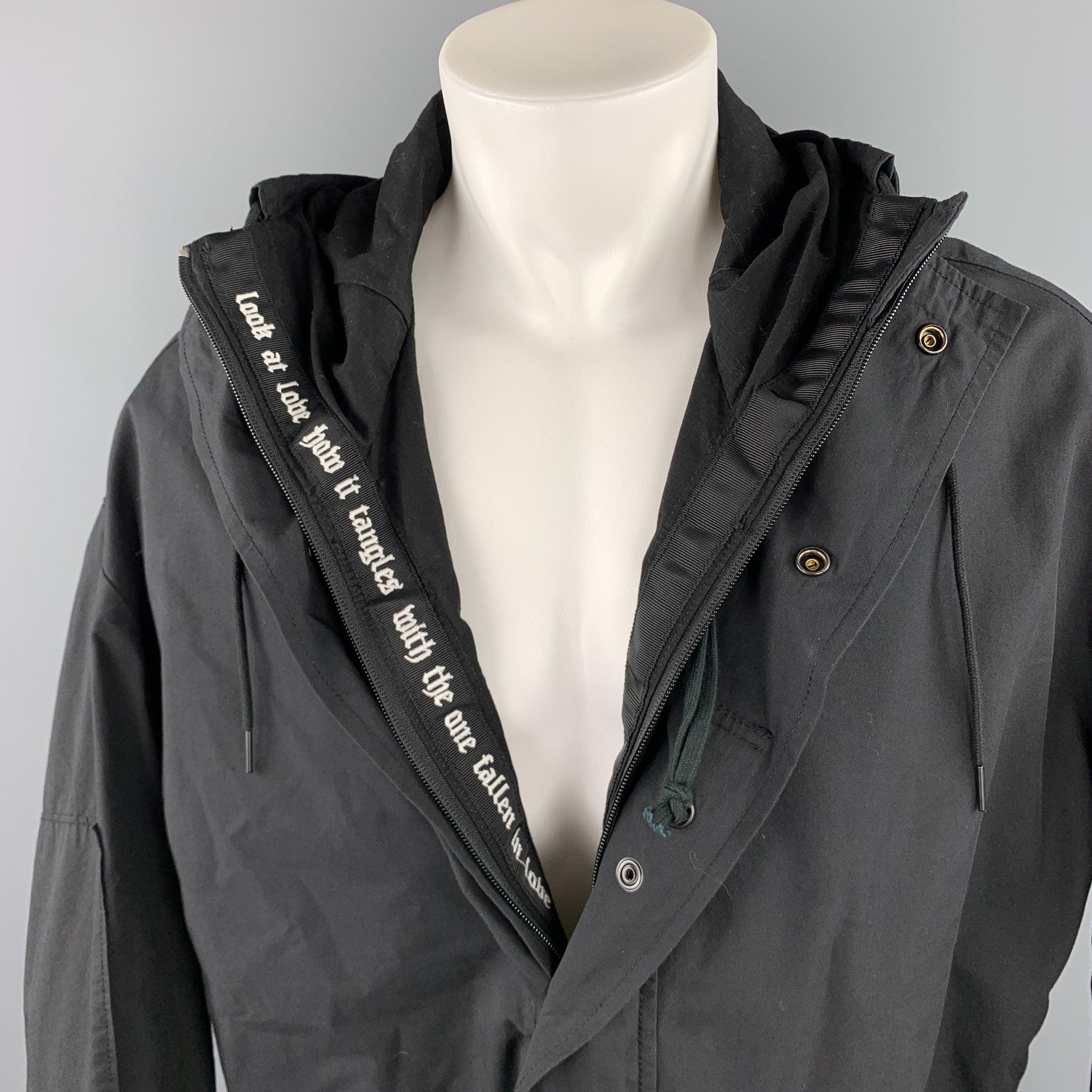 R 13 coat comes in a black cotton / nylon featuring a oversized style, inner embroidery detail, hooded, large zipper pockets, drawstring, and a zip & snap button closure.
Very Good
Pre-Owned Condition. 

Marked:  XS 

Measurements: 
 
Shoulder: 25