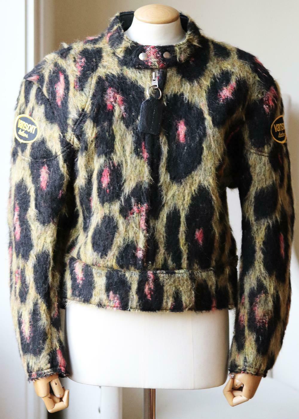 Oversized outerwear is a signature of R13, this leather biker jacket has leopard-print mohair-style outer material and patch detail.
Green, pink and black polyester, black leather.
Velcro and zip fastening through front.
55% Goat leather, 29%