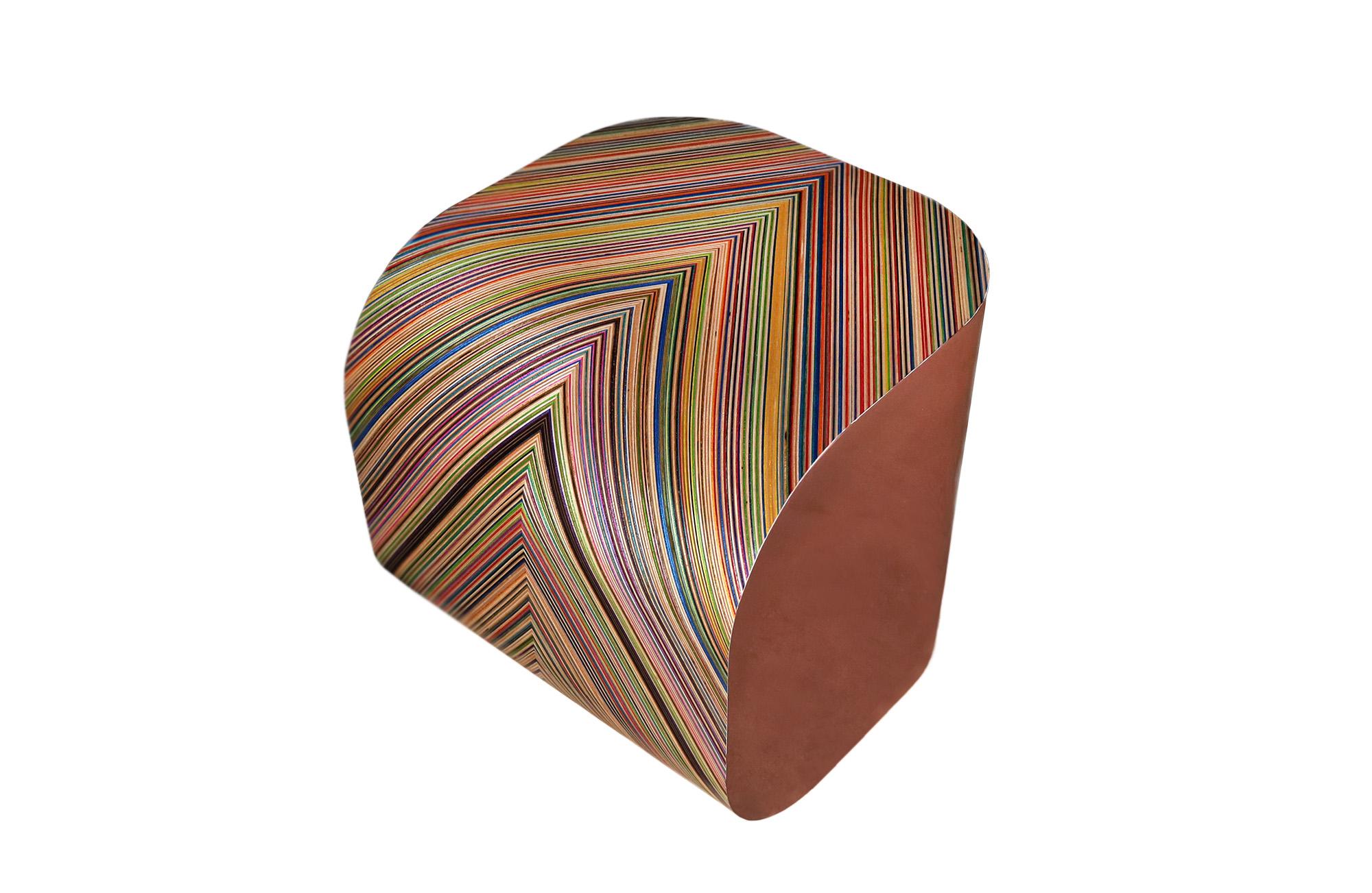 The 'R5' end table boasts vibrant skateboard pattern and a rich copper finish. Its harmonious blend of form and function creates a visually appealing table. Its illuminating glow from the copper and colourful skateboard palette brings a sense of