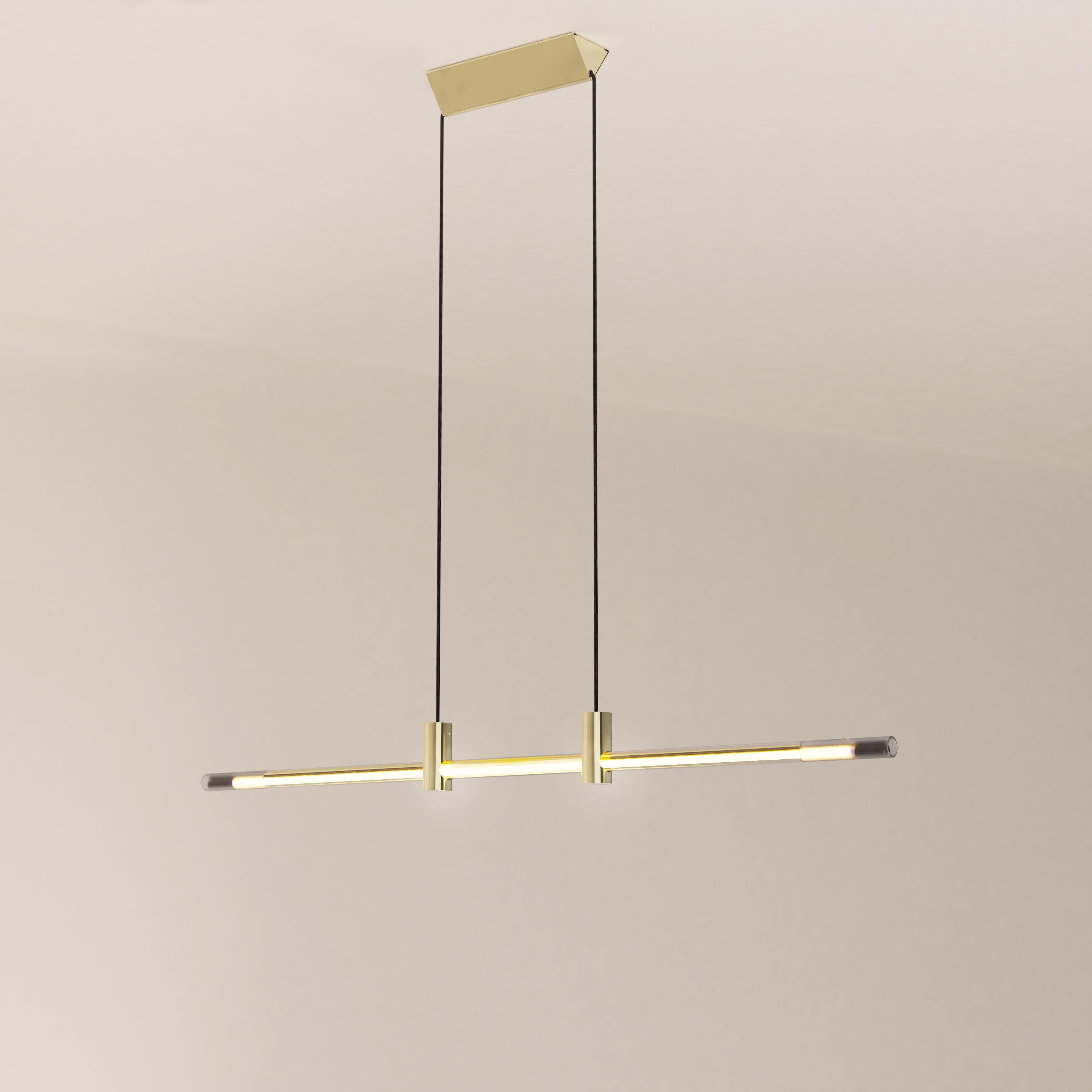 The Ra Line in its brass plated finish is a contemporary hand-blown glass and brass pendant lighting.

The Ra Line is distinguished by a marked opposition between heaviness and lightness. The assemblage of the borosilicate glass tube that
pierces