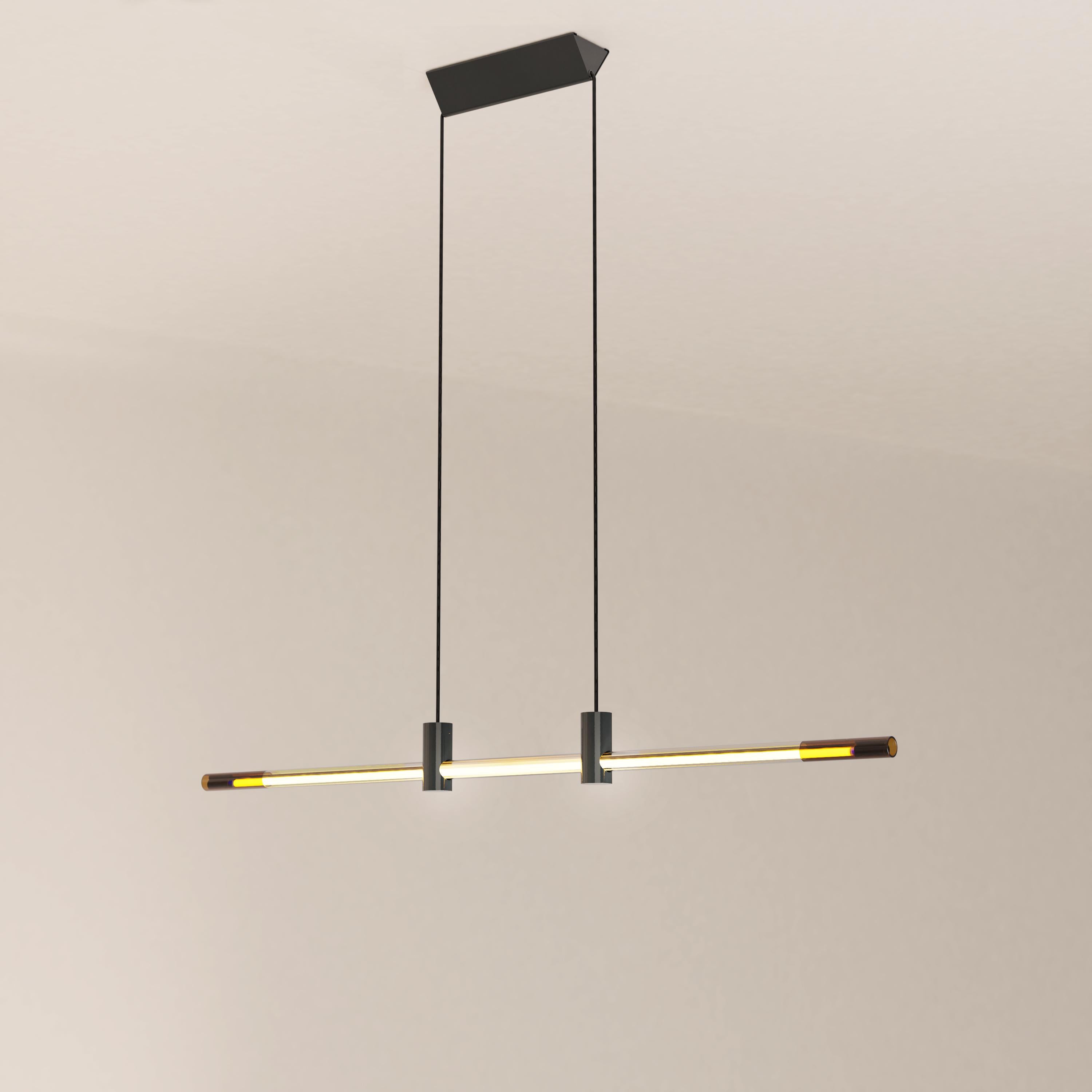 The Ra Line in its glossy black painted finish is a contemporary hand-blown glass and aluminum pendant lighting with cold cathode neon.

The Ra Line is distinguished by a marked opposition between heaviness and lightness. The assemblage of the