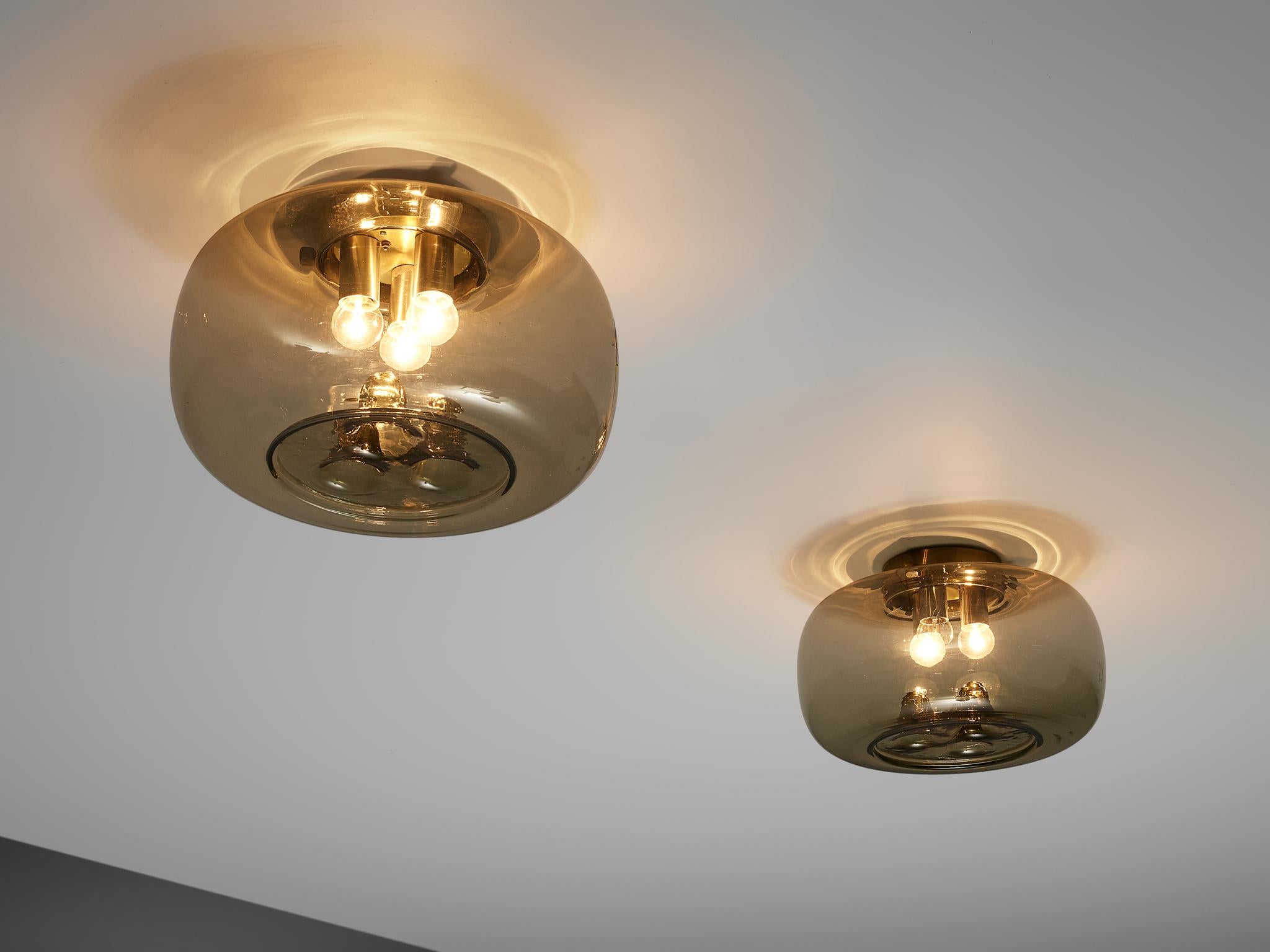 RAAK Amsterdam, ceiling light, smoked glass, brass, the Netherlands, 1970s

These beautifully designed glass shades by RAAK Amsterdam hold three small light bulbs, attached to brass cylindrical mountings. On the opposite side of the shade, three