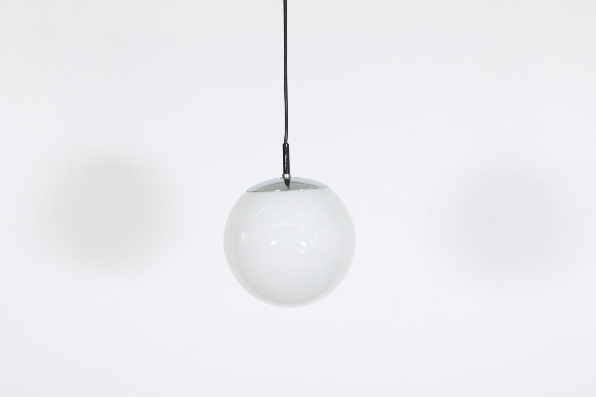 RAAK (attr) Opaline Glass Globe Pendant Lights with chrome hardware In Good Condition For Sale In Los Angeles, CA