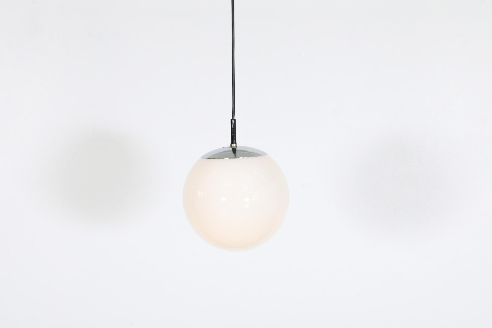 Mid-20th Century RAAK (attr) Opaline Glass Globe Pendant Lights with chrome hardware For Sale