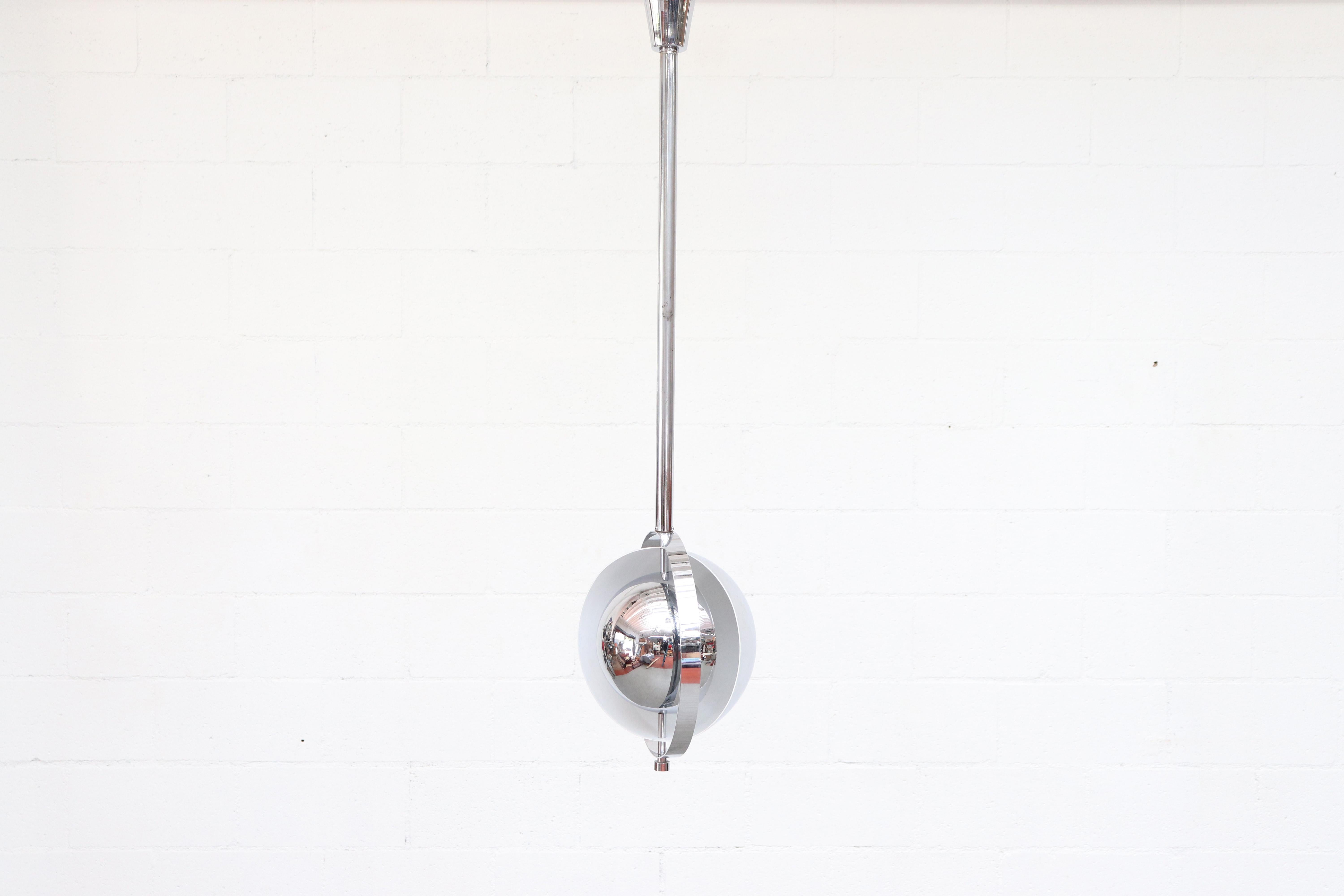 Cool chrome hanging Henri Matthieu style orbit light. Rotating chrome ring and half-moon domes as well as height adjustable!!! Original condition with nice patina to the chrome. One slight dent in the outer shell.