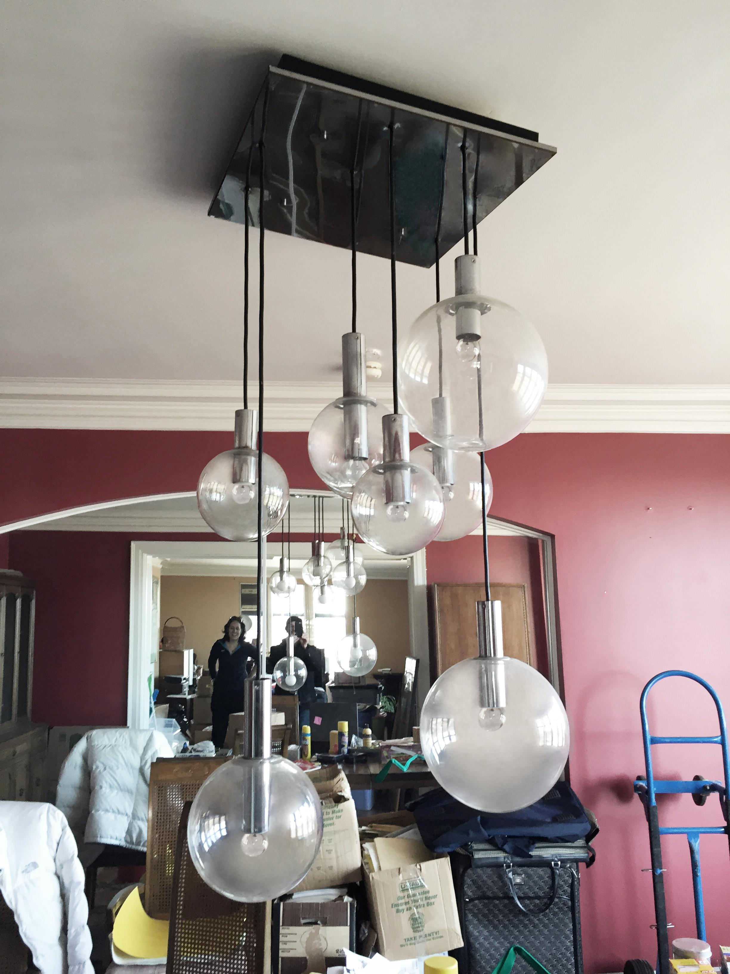An eight pendant RAAK chandelier. Very nice scale for residential or office. The lamp hanging length can be modified longer or shorter (easily) to ones taste.

may require a few replacement globes pending on perfection. Otherwise very nice!

In the