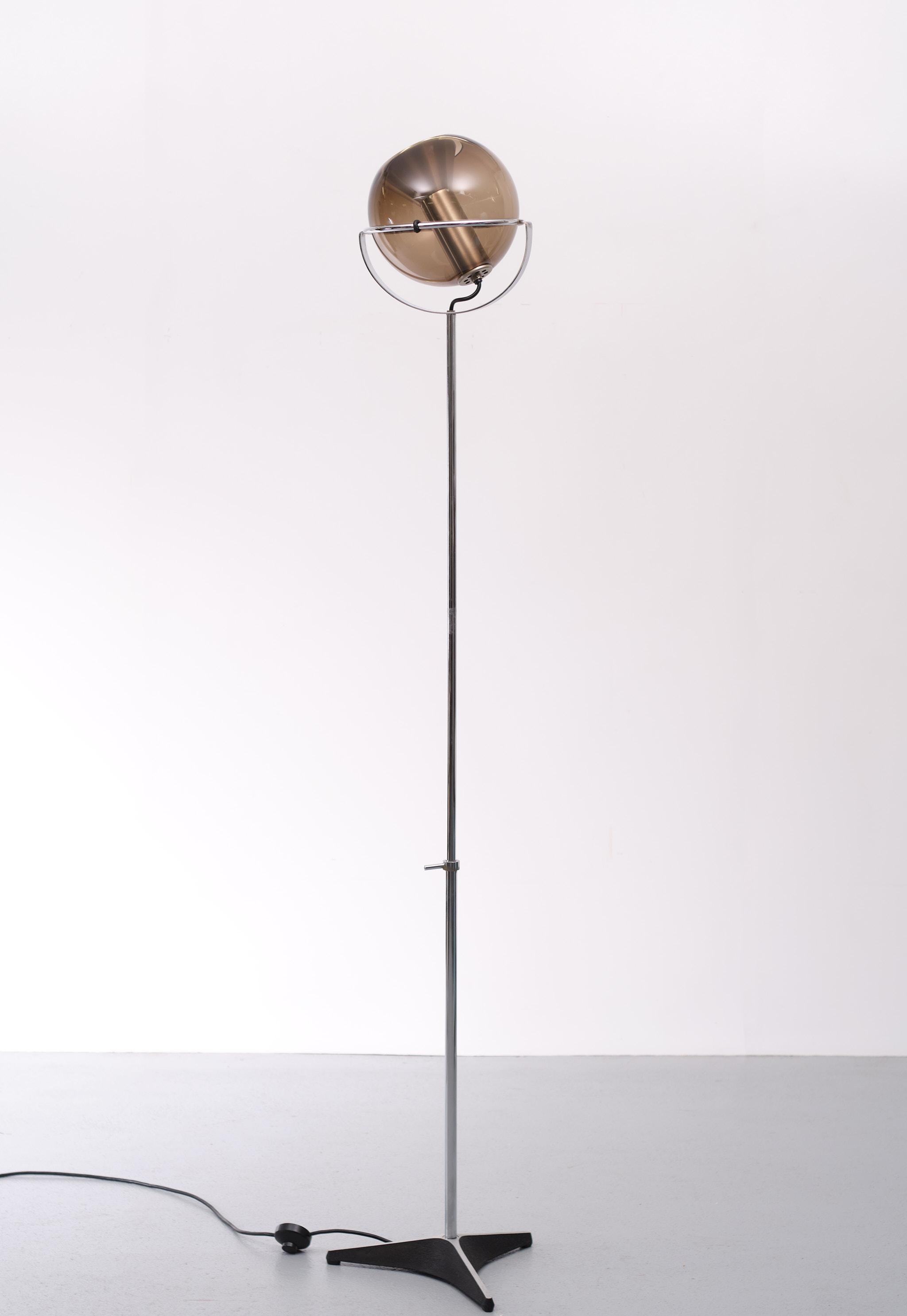 What a very nice Design by Frank Ligtelijn for Raak Amsterdam Model  Globe  
Smoked Glass shade inside a pierced Aluminum lamp holder .adjustable Chrome upright on a Star shaped feet . very good condition . Height 120 cm/ 177 cm .
 
. 
 