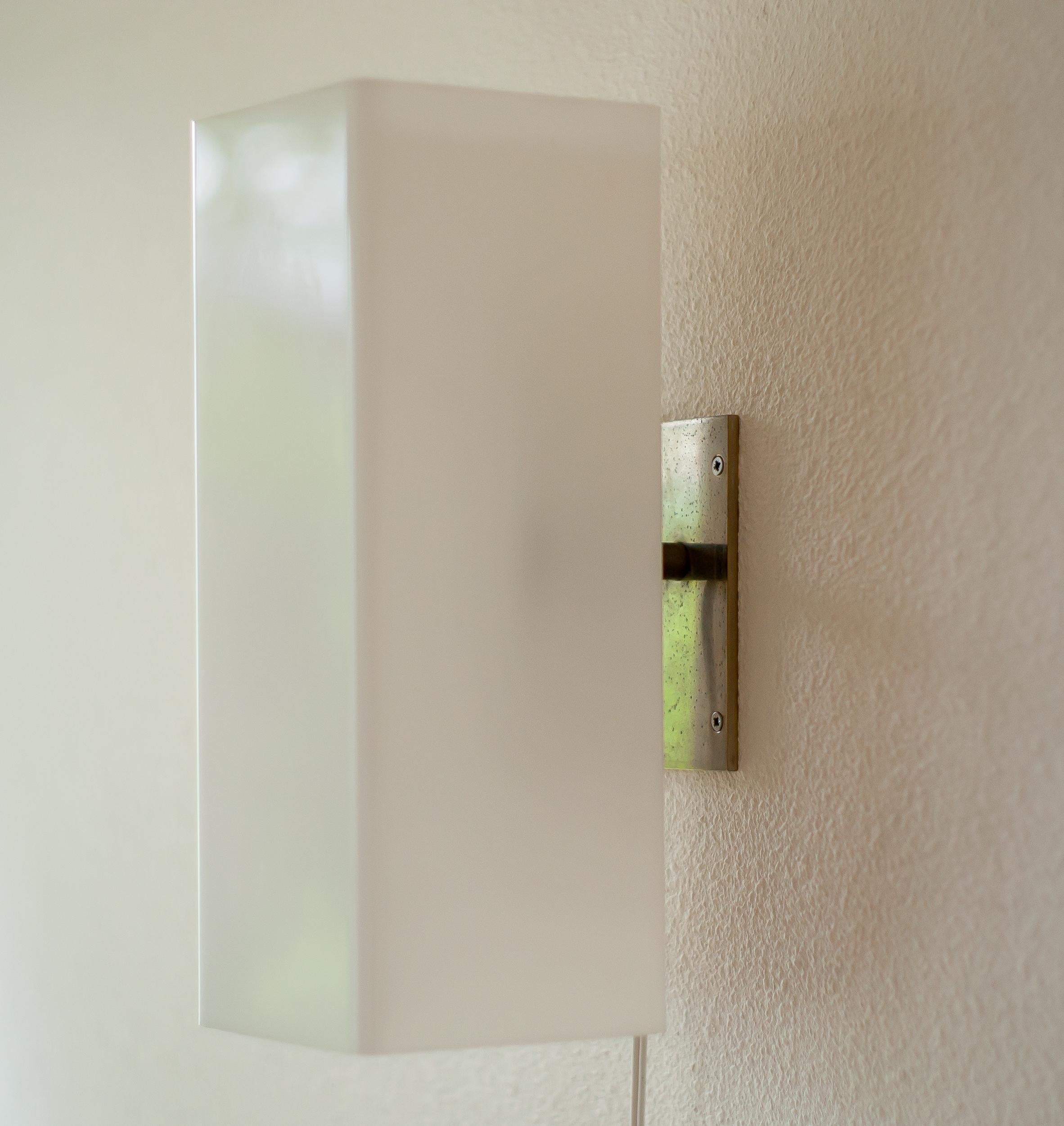 Large, well made architectural wall lamp with a nickel-plated steel frame and white Lucite shade.
The lamp came from a modernist home in Holland where it had been in use since the 1960s.
Contrary to its strict appearance, it gives a very