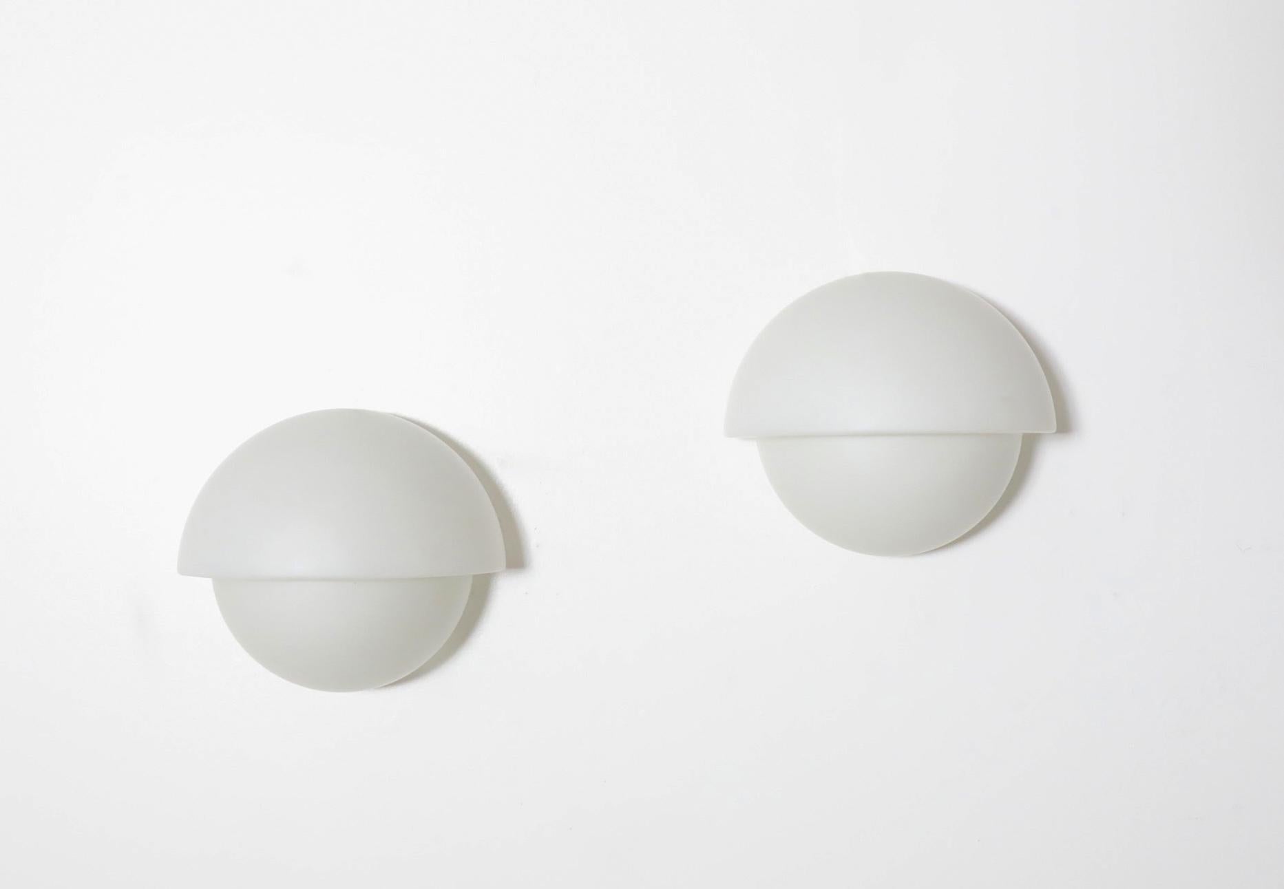 Mid-Century., 1960's architectural milk glass wall mounted sconces by Sergio Asti. Sergio Asti, born in Milan in 1926, opened his own office in 1953. His diverse portfolio includes designs for architecture, furniture, lighting, and glass. In 1957,