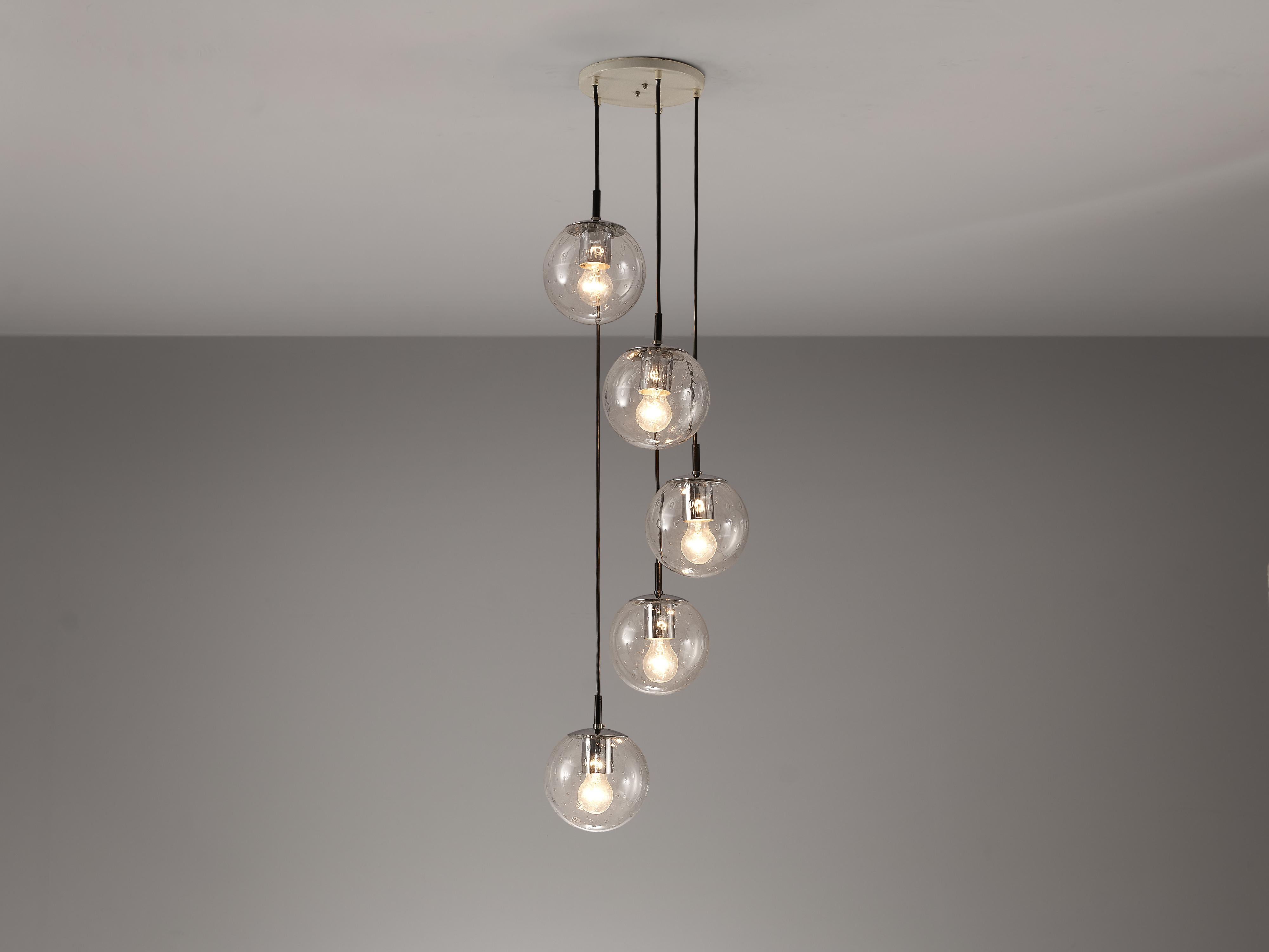 RAAK Amsterdam, pendant with five 'Bubble' spheres, glass, chrome-plated metal, The Netherlands, 1960s 

A sophisticated composition of five hand-blown glass pendants is created by the Dutch manufacturer RAAK Amsterdam. As a result of the
