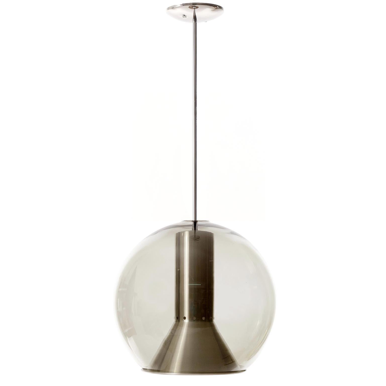 One of three pendant lights or hanging lamps designed by Frank Ligtelijn for RAAK Amsterdam, Netherlands, manufactured in midcentury, circa 1970 (late 1960 or ealry 1970s).
Each light features a grey smoked glass globe with an aluminium reflector