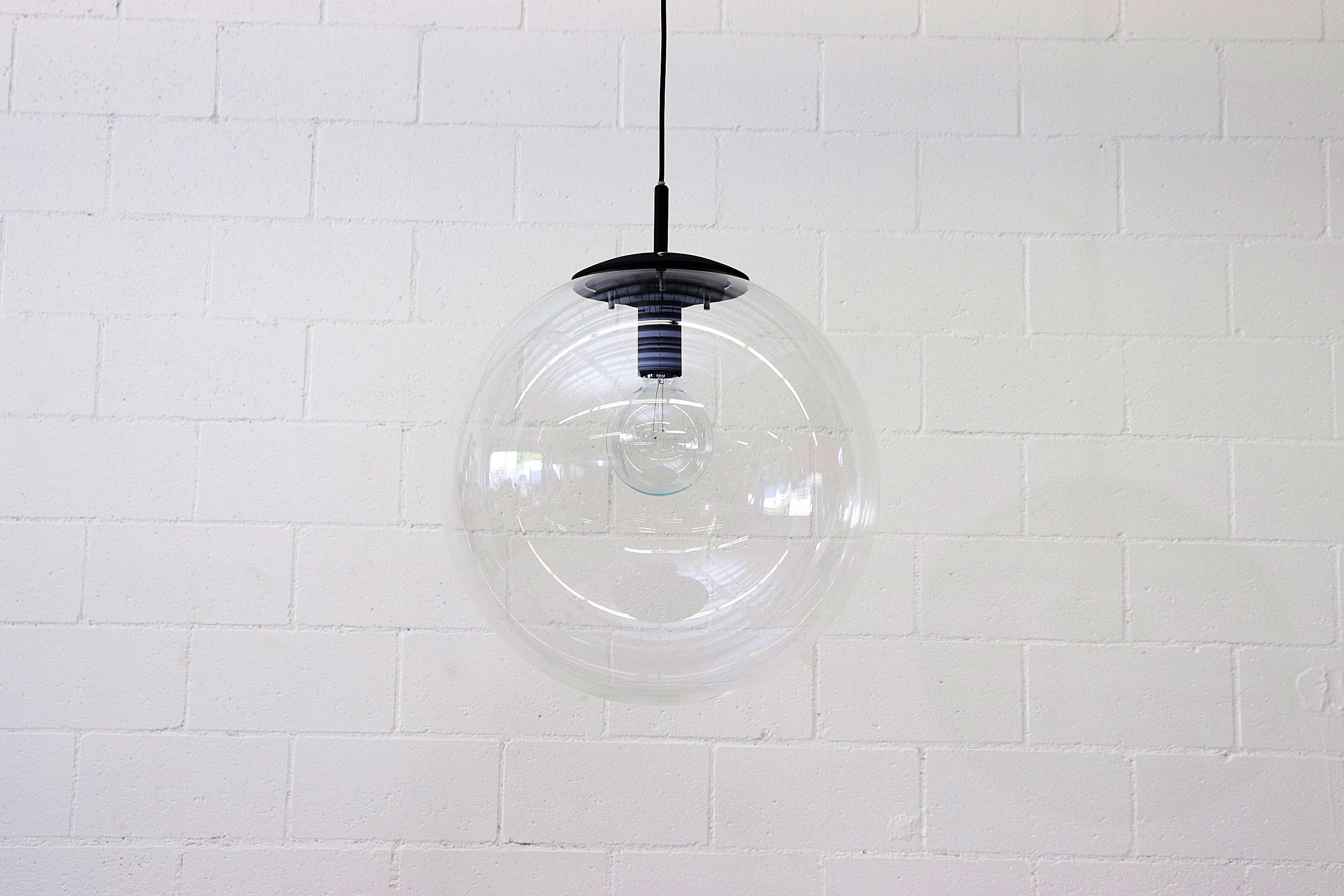 Jumbo Clear Acrylic Globe Lights with Black Enameled Hardware and Standard Light Socket. In Original Condition. Shot with G40 Bulb (not included). Other Similar Globe Pendants Available and Listed Separately.